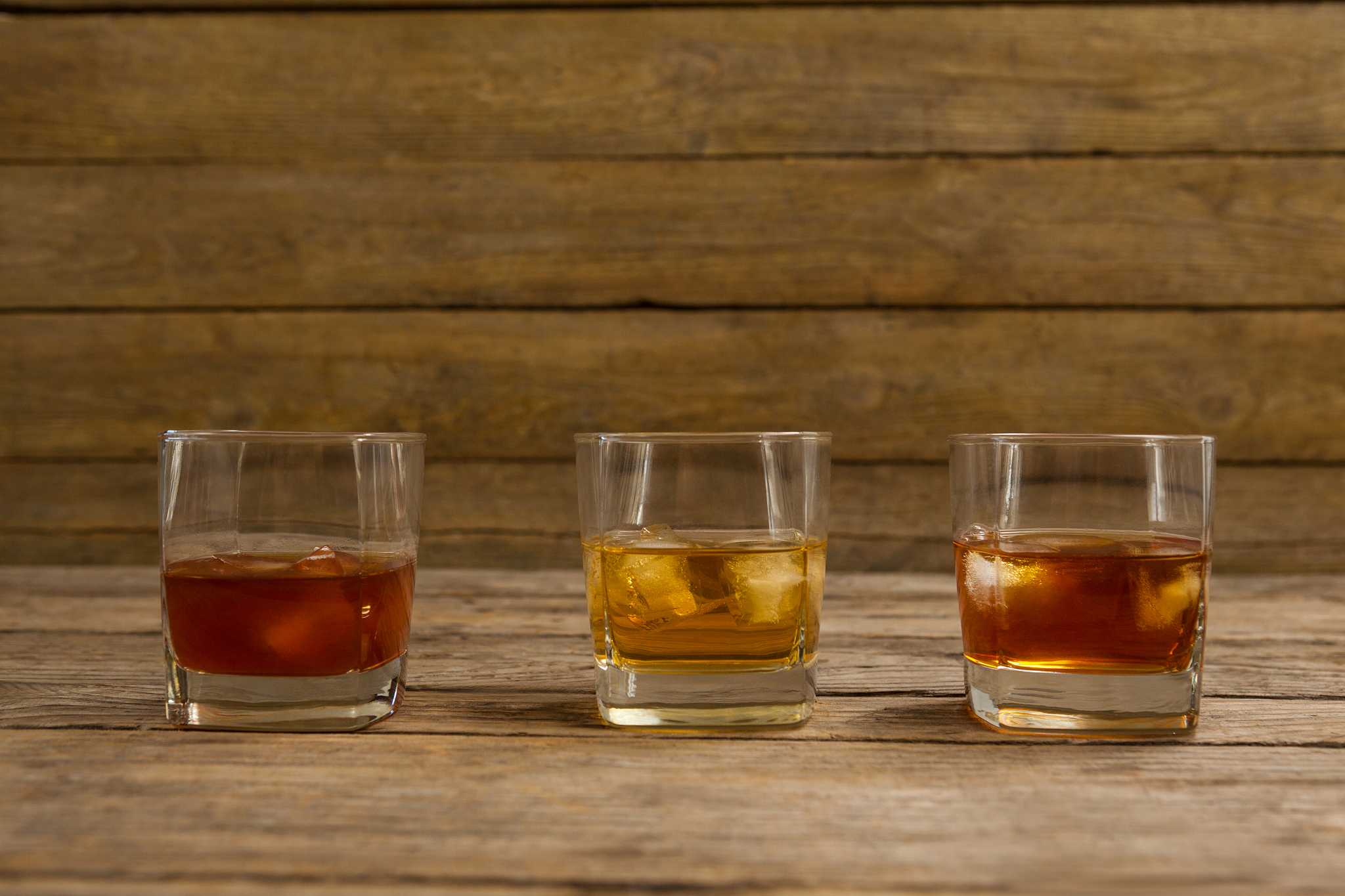 three glasses of whiskey with ice cube