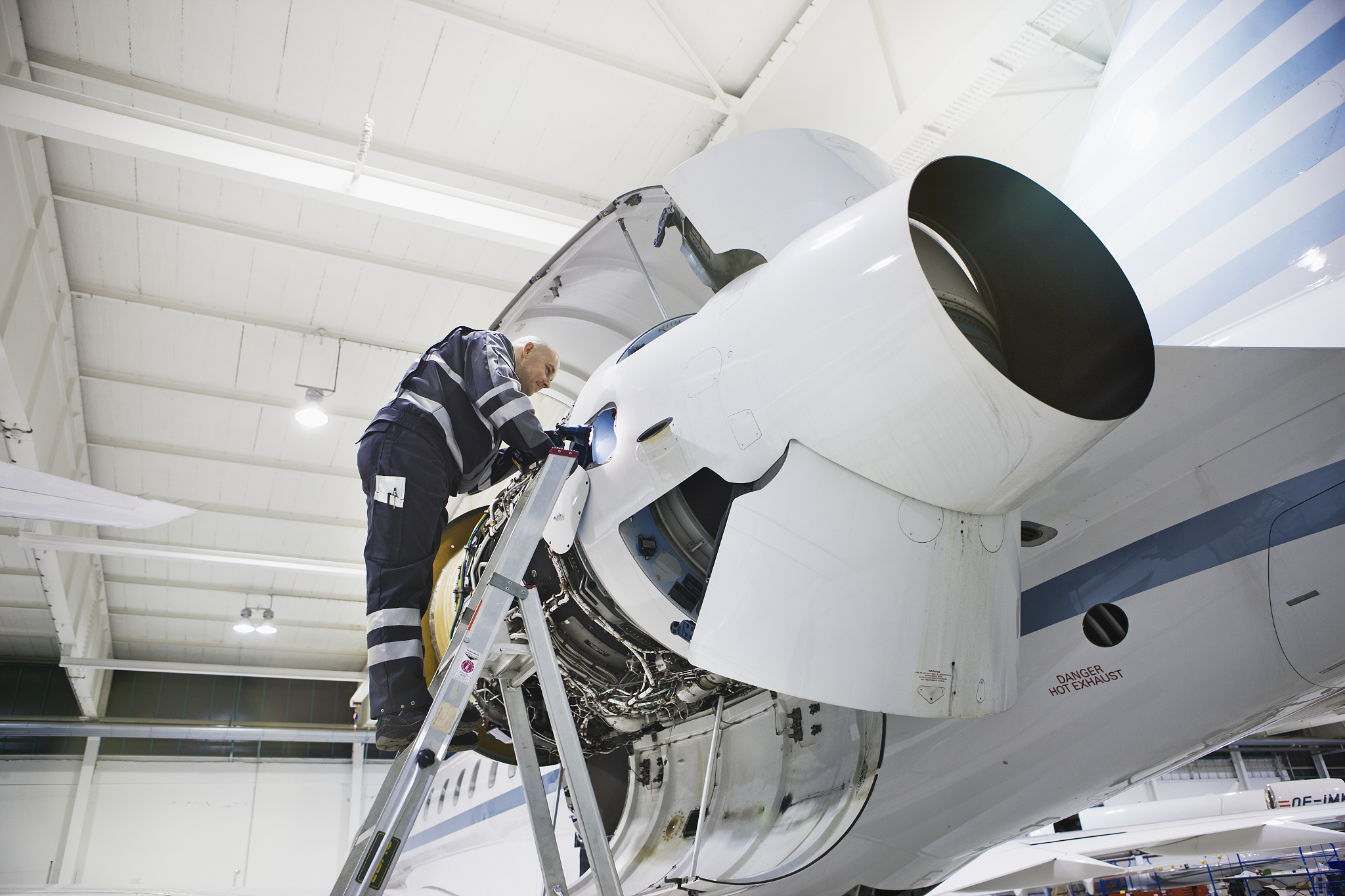 mechanic working on airplane engine at factory