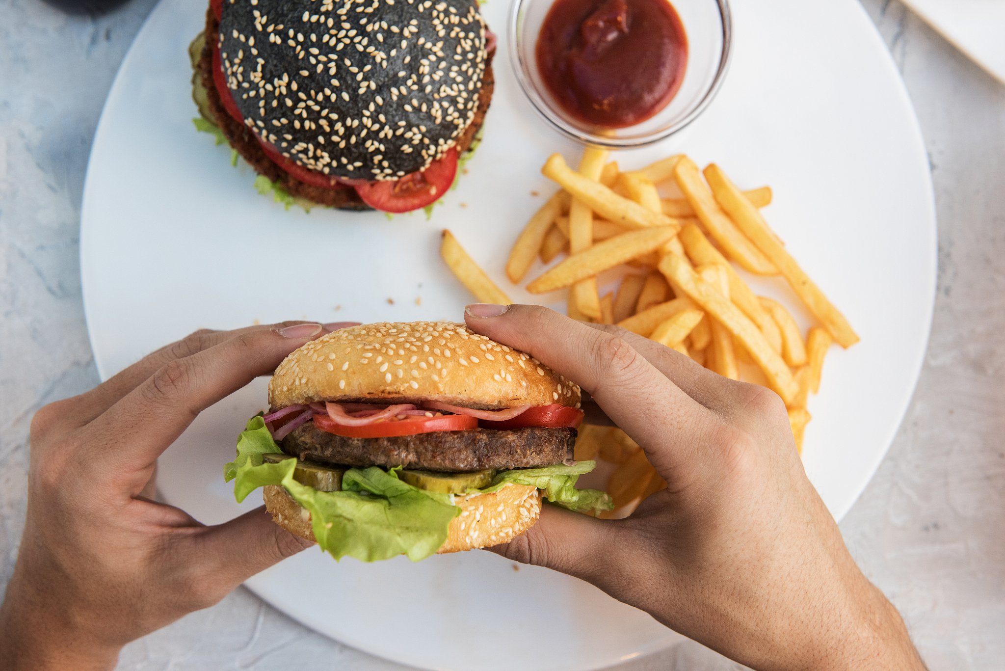 man eating burgers