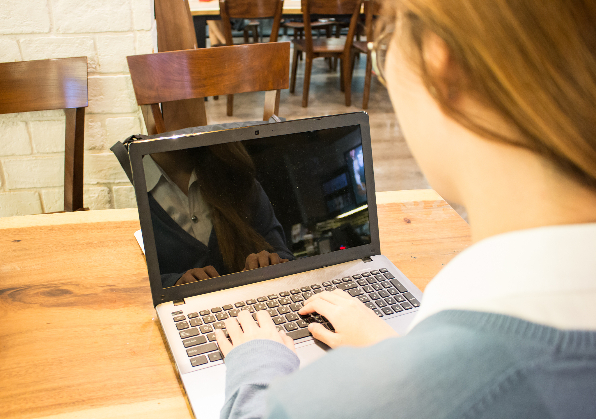 asian woman student working on a laptop