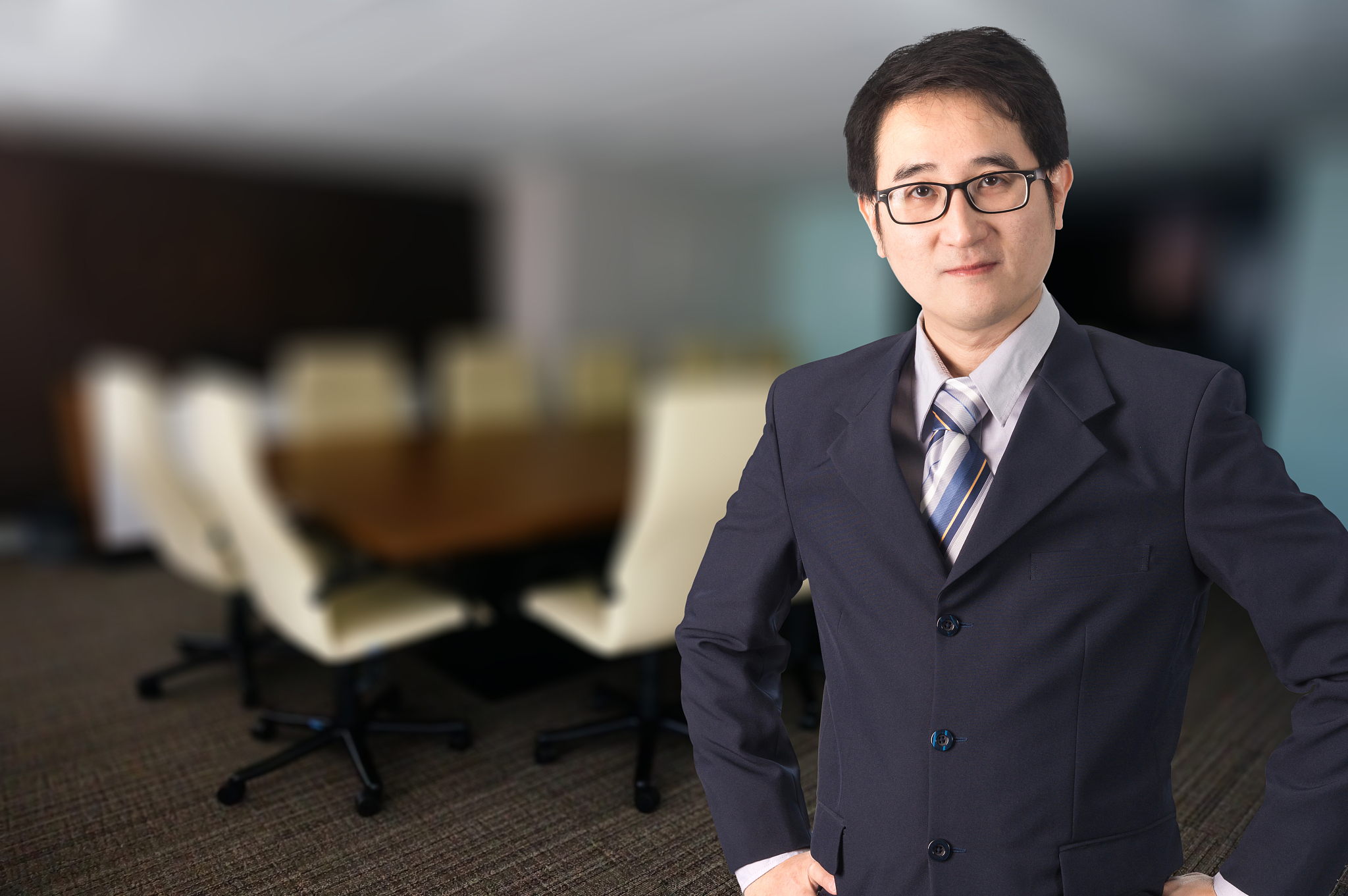 portrait of businessman wearing eyeglasses while standing in off