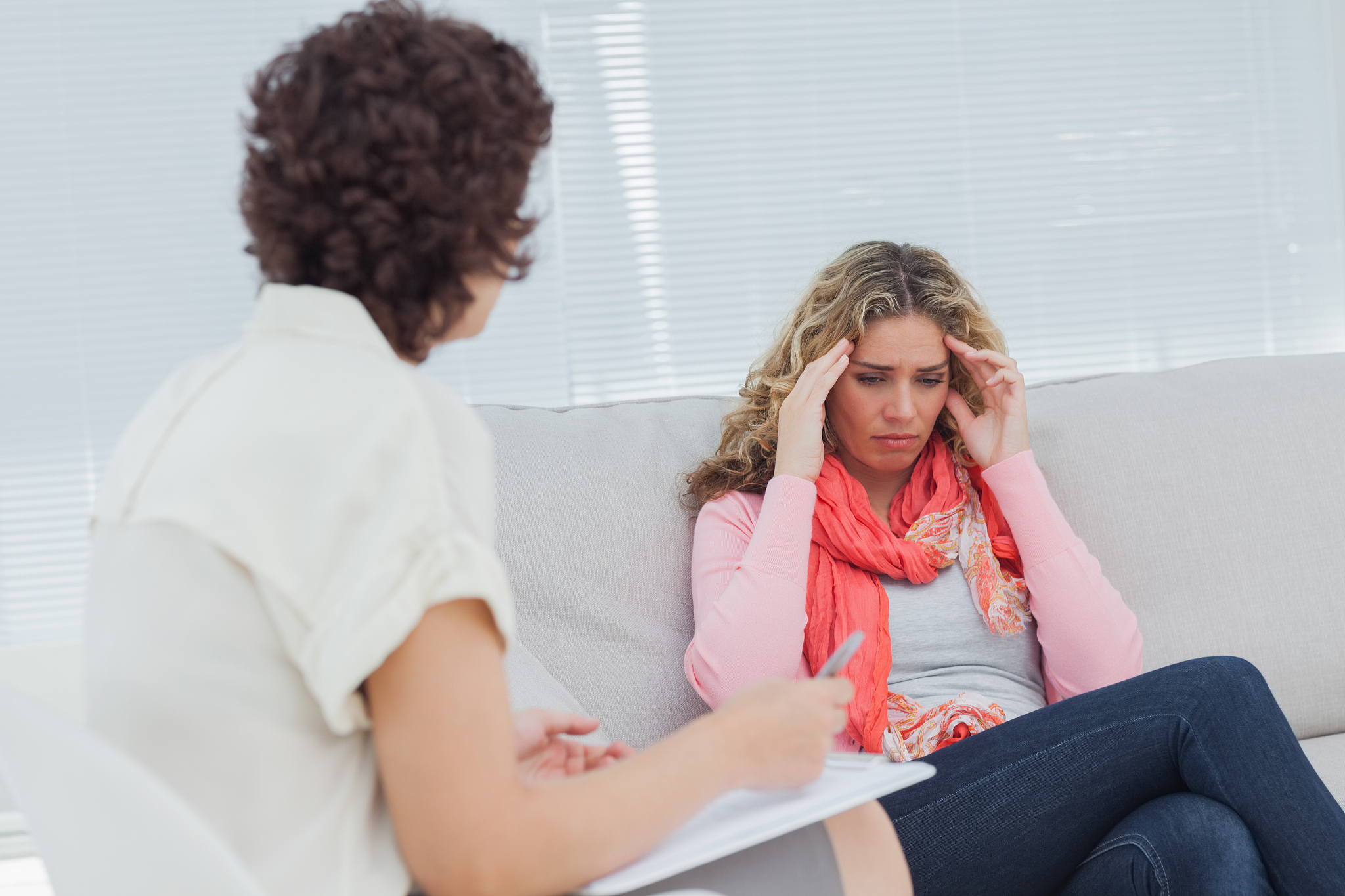 upset woman crying on couch