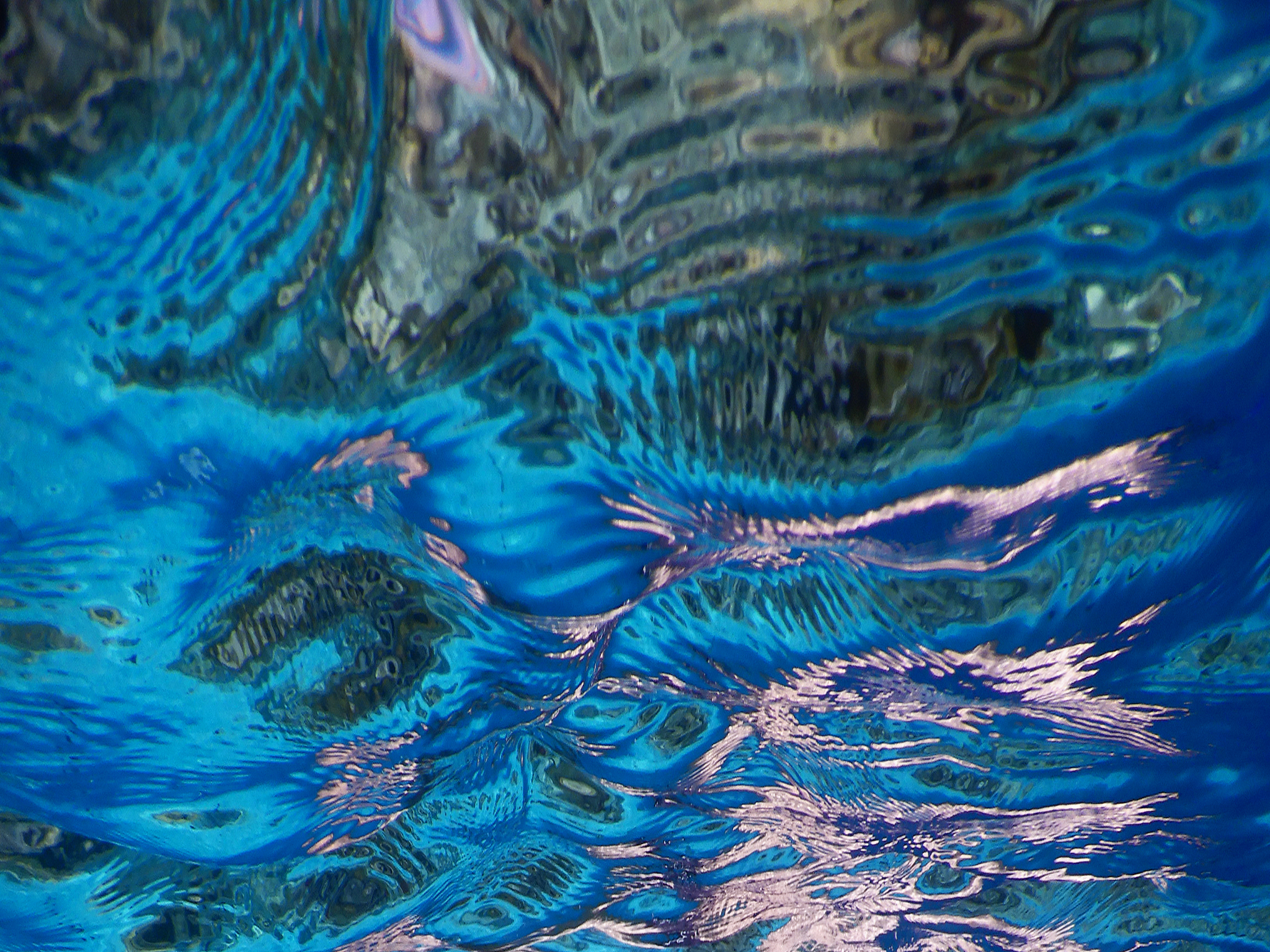 multi-colored reflections on the lower surface of tropical lagoo
