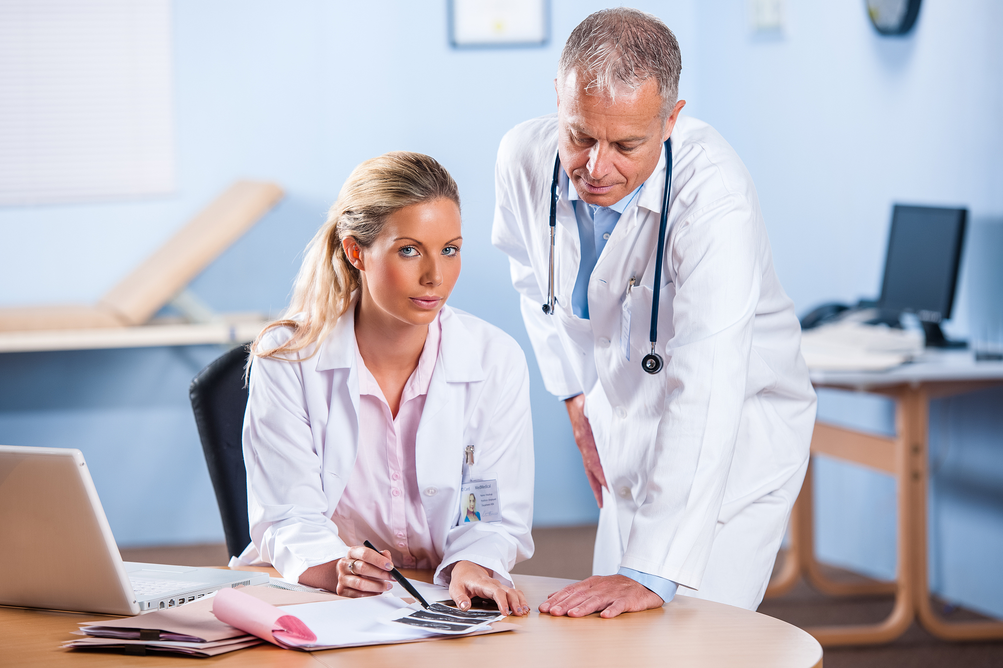 medical doctors reviewing notes/ scans