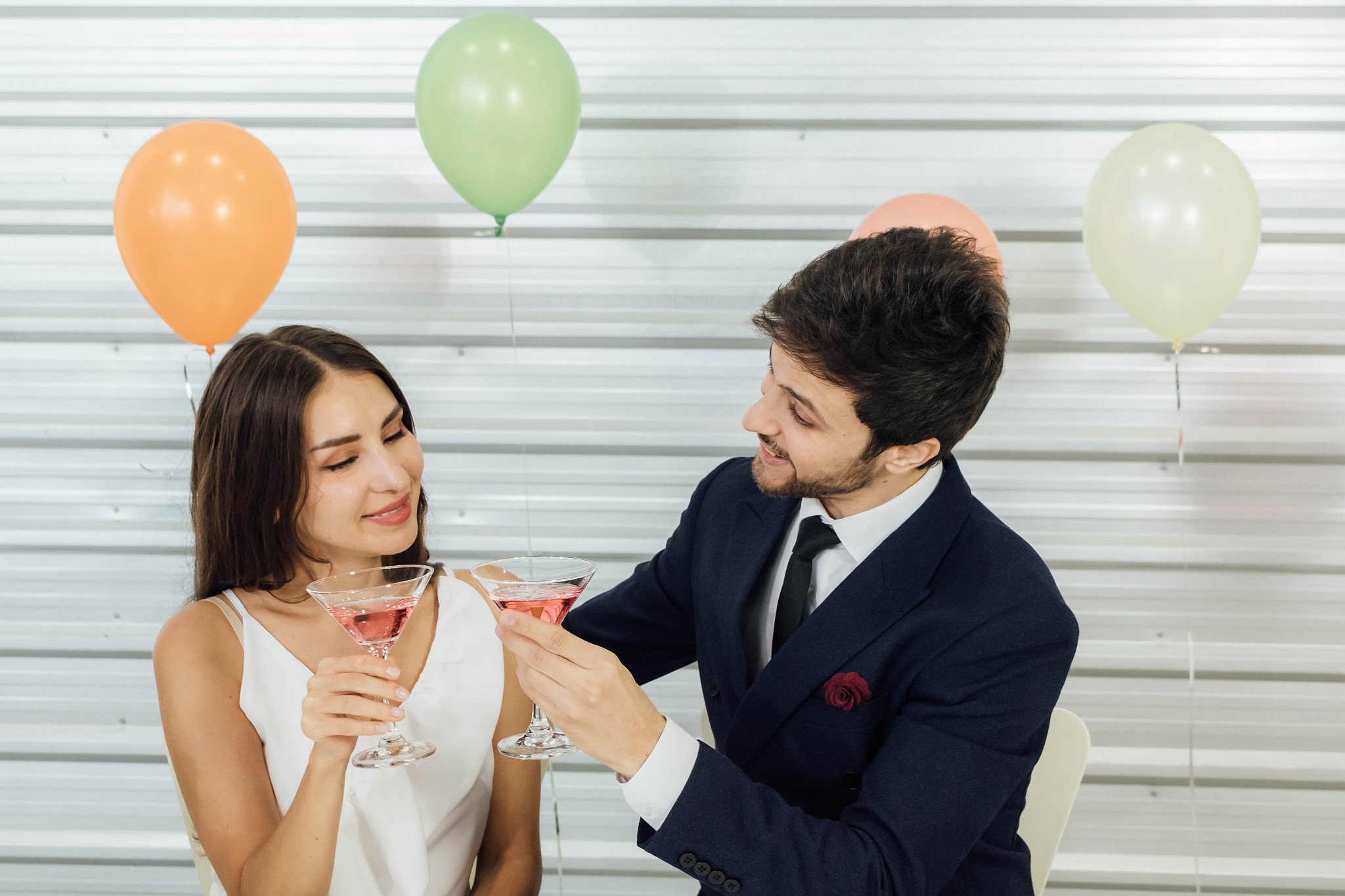 the caucasian couple enjoys drinking at a party.