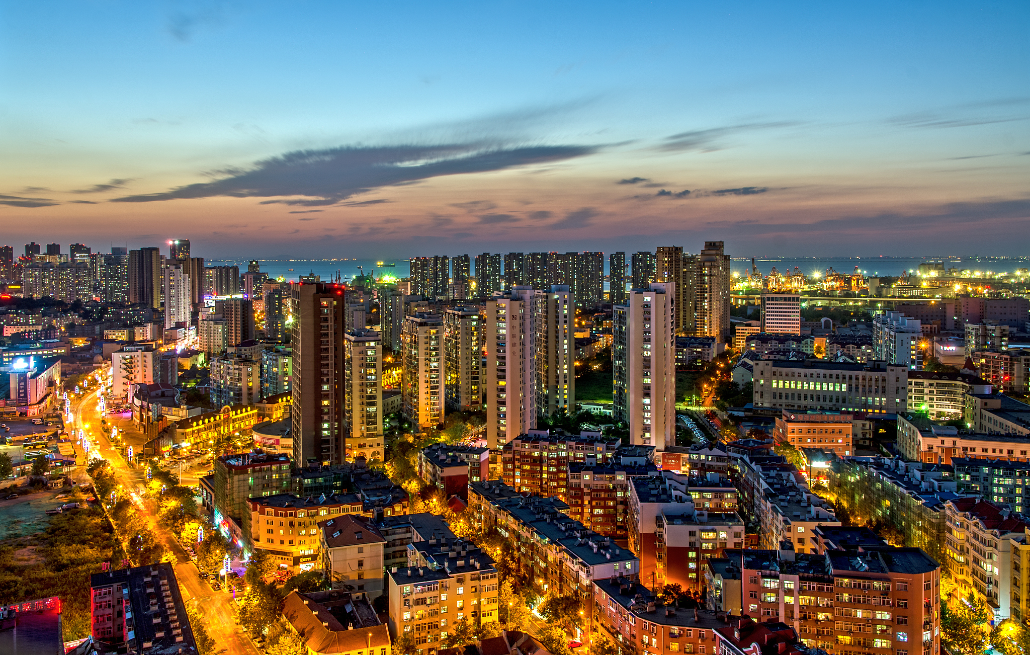high angle view of illuminated cityscape against sky during suns