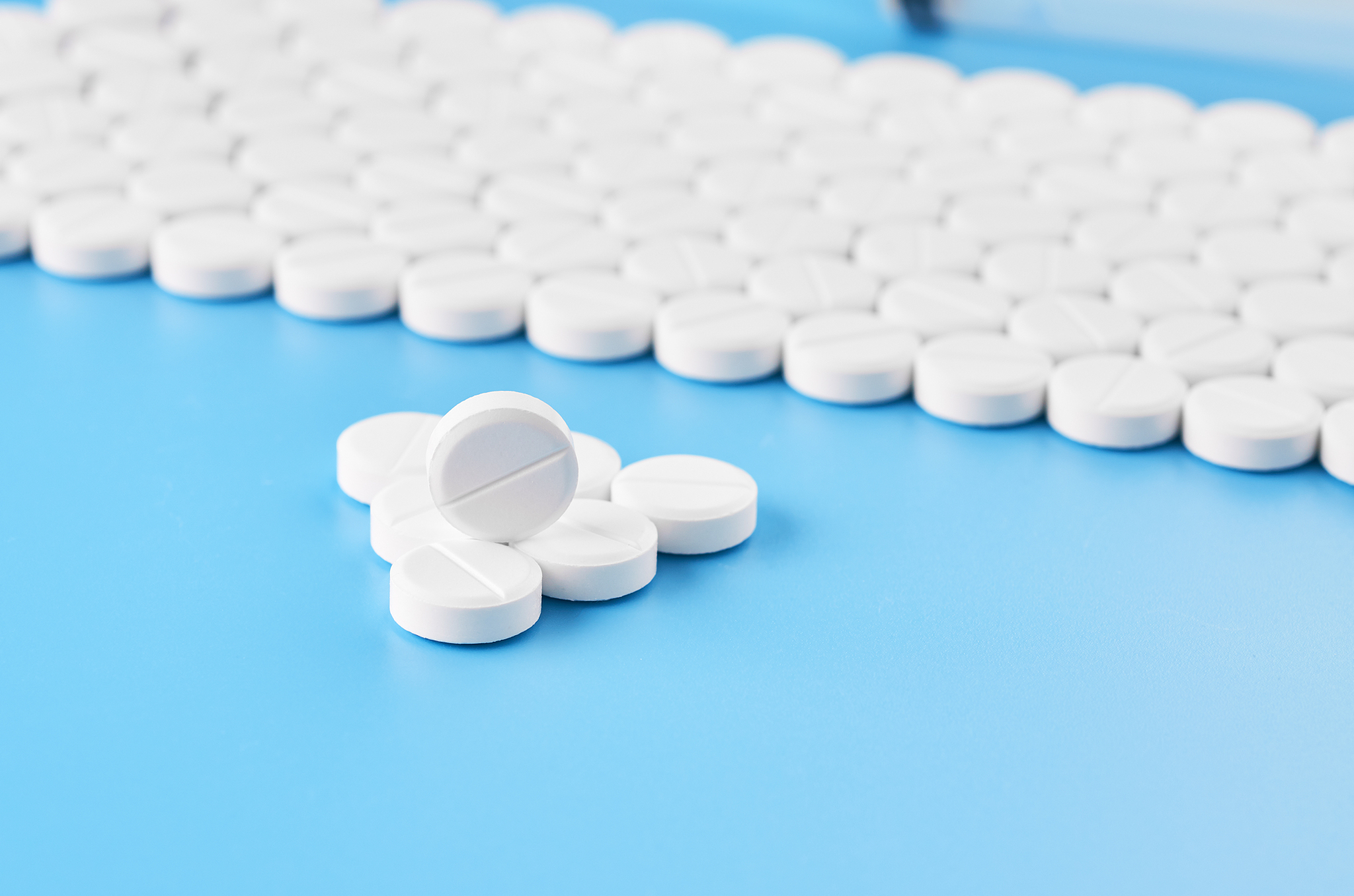 pills tablets capsules closeup. on a blue background, a jar of m