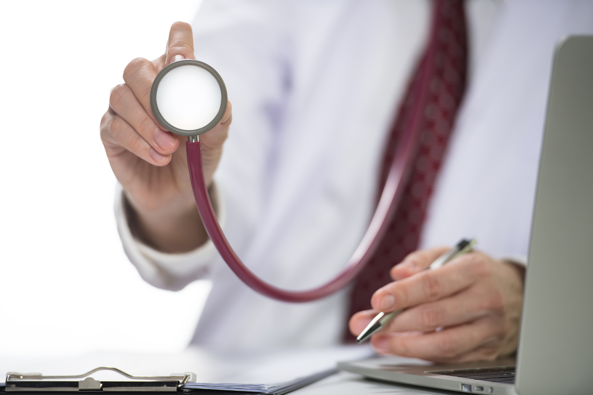 medical doctor holding stethoscope in hospital setting