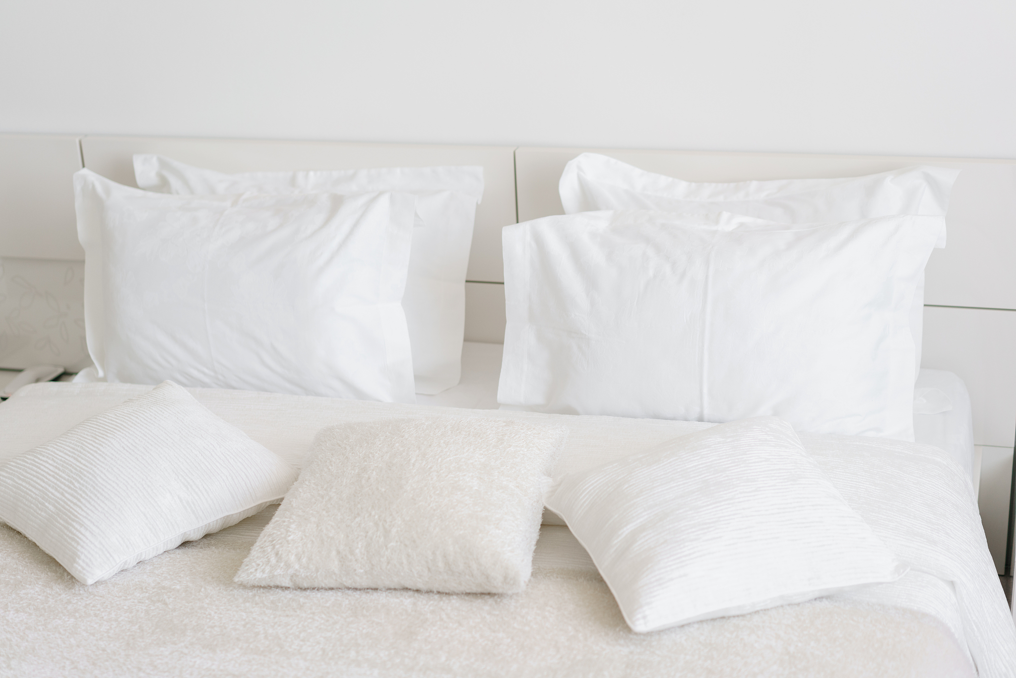 comfortable soft pillows on the bed. close-up white bedding shee