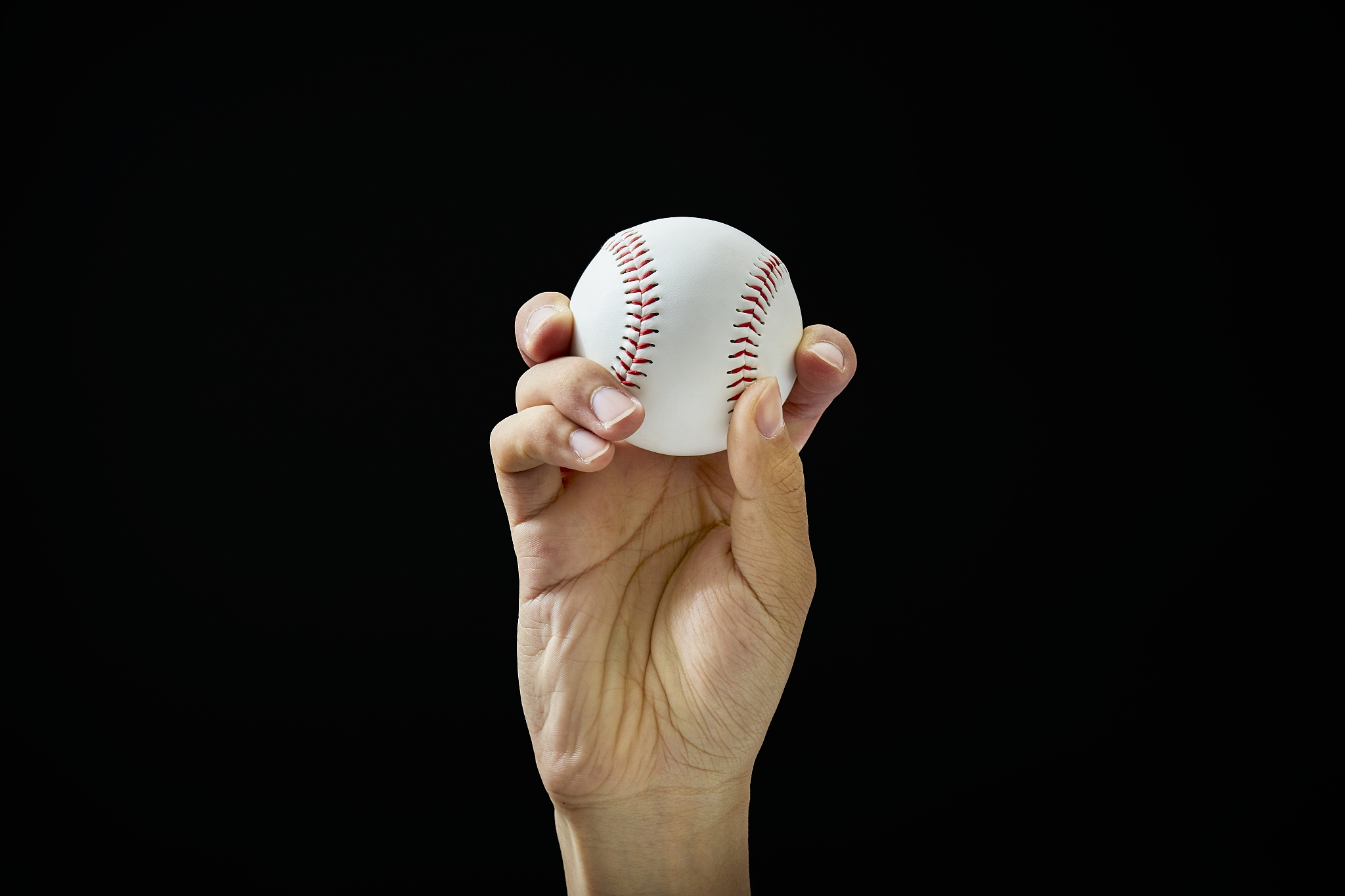 male hand holding baseball ball