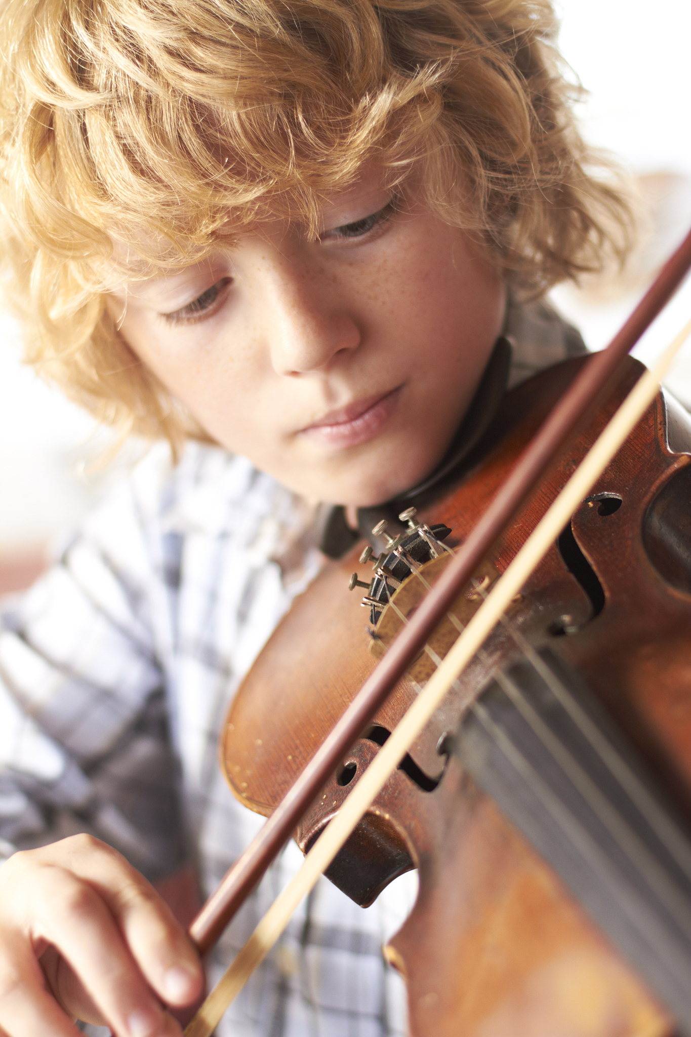 boy practicing violin at home