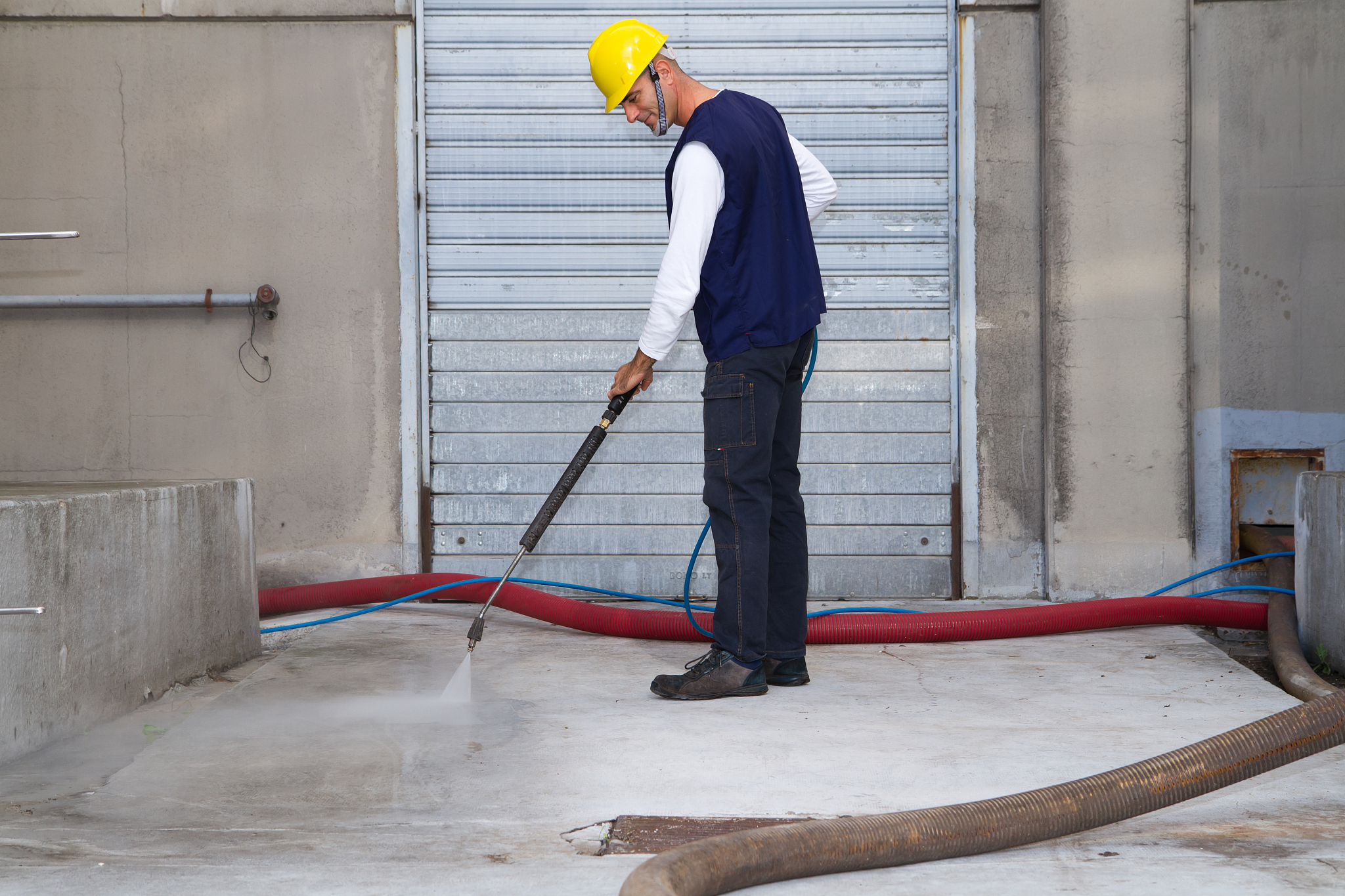 electrician and general worker washing  the floor