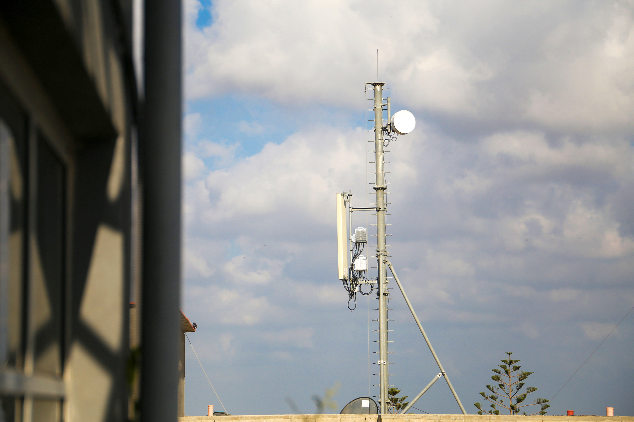 cell phone telecommunication tower with clouds,blue sky