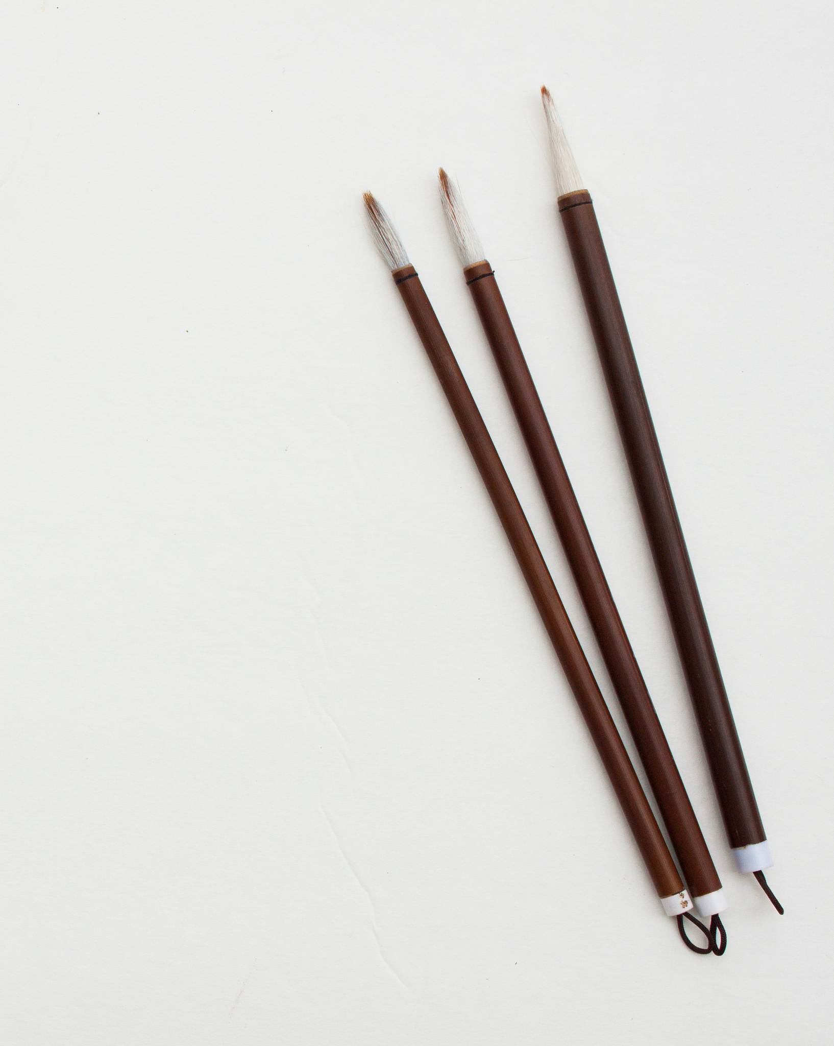 three calligraphy brushes