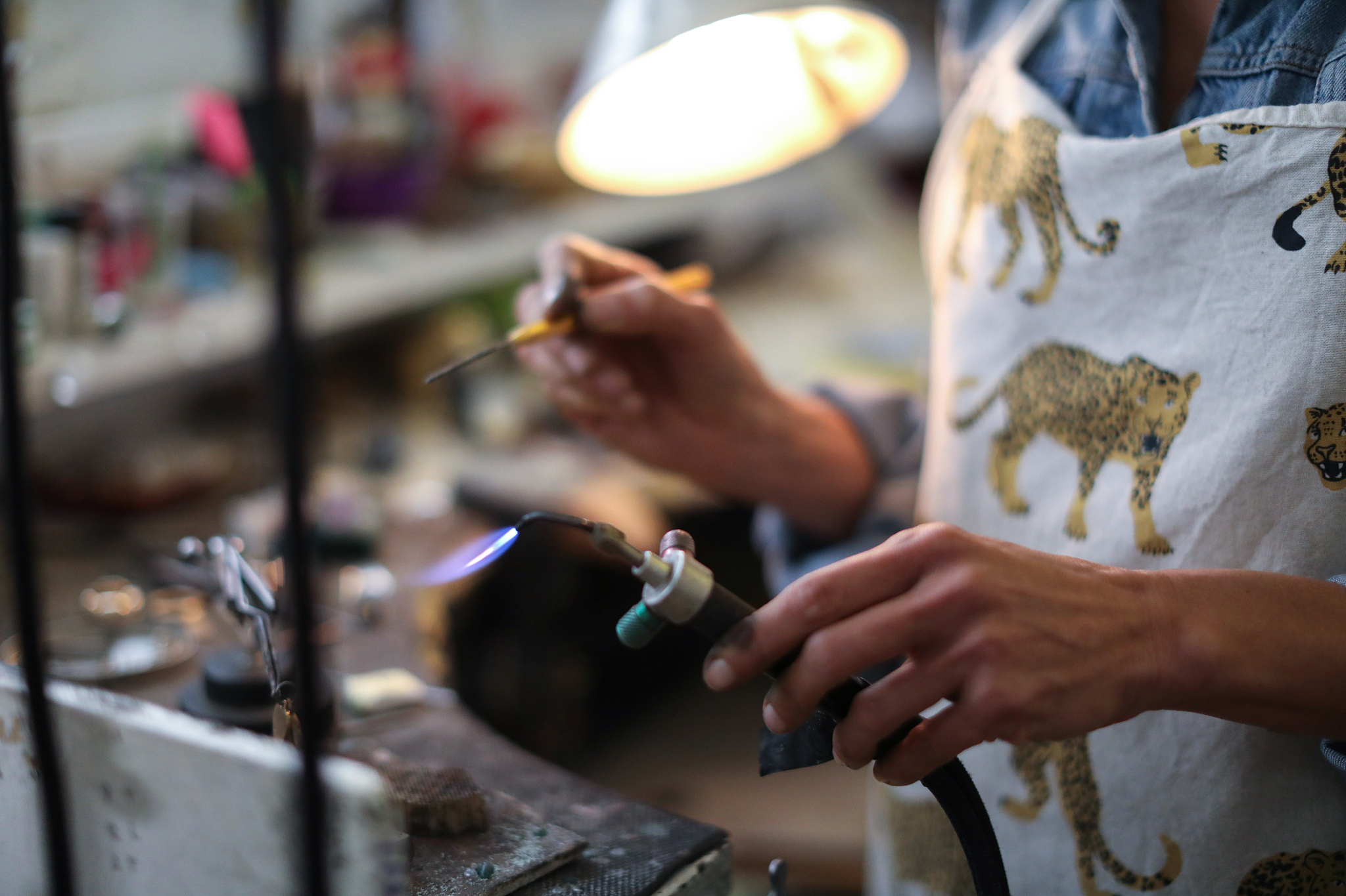 a jewellery designer working in her studio.