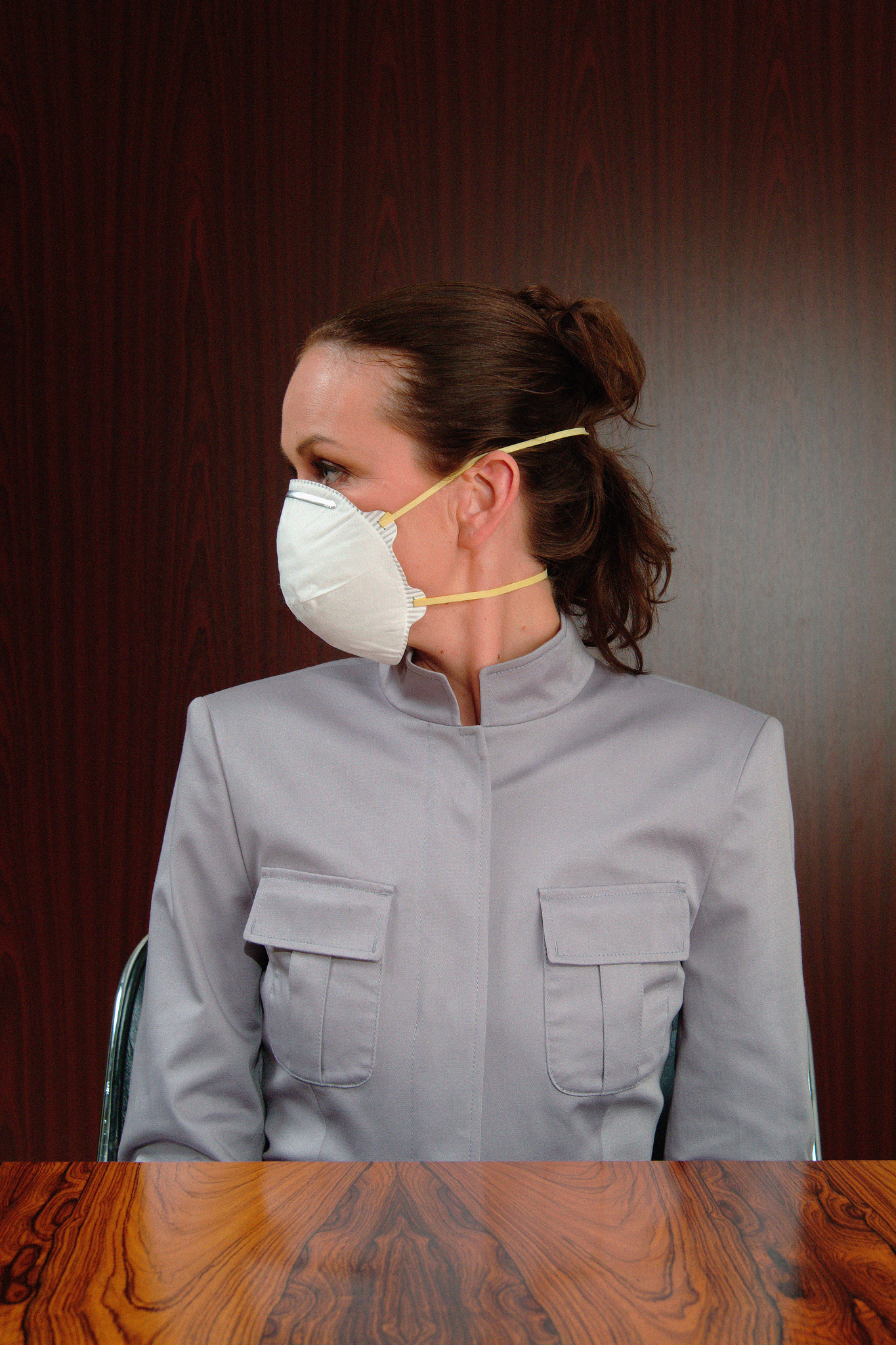 masked woman in boardroom