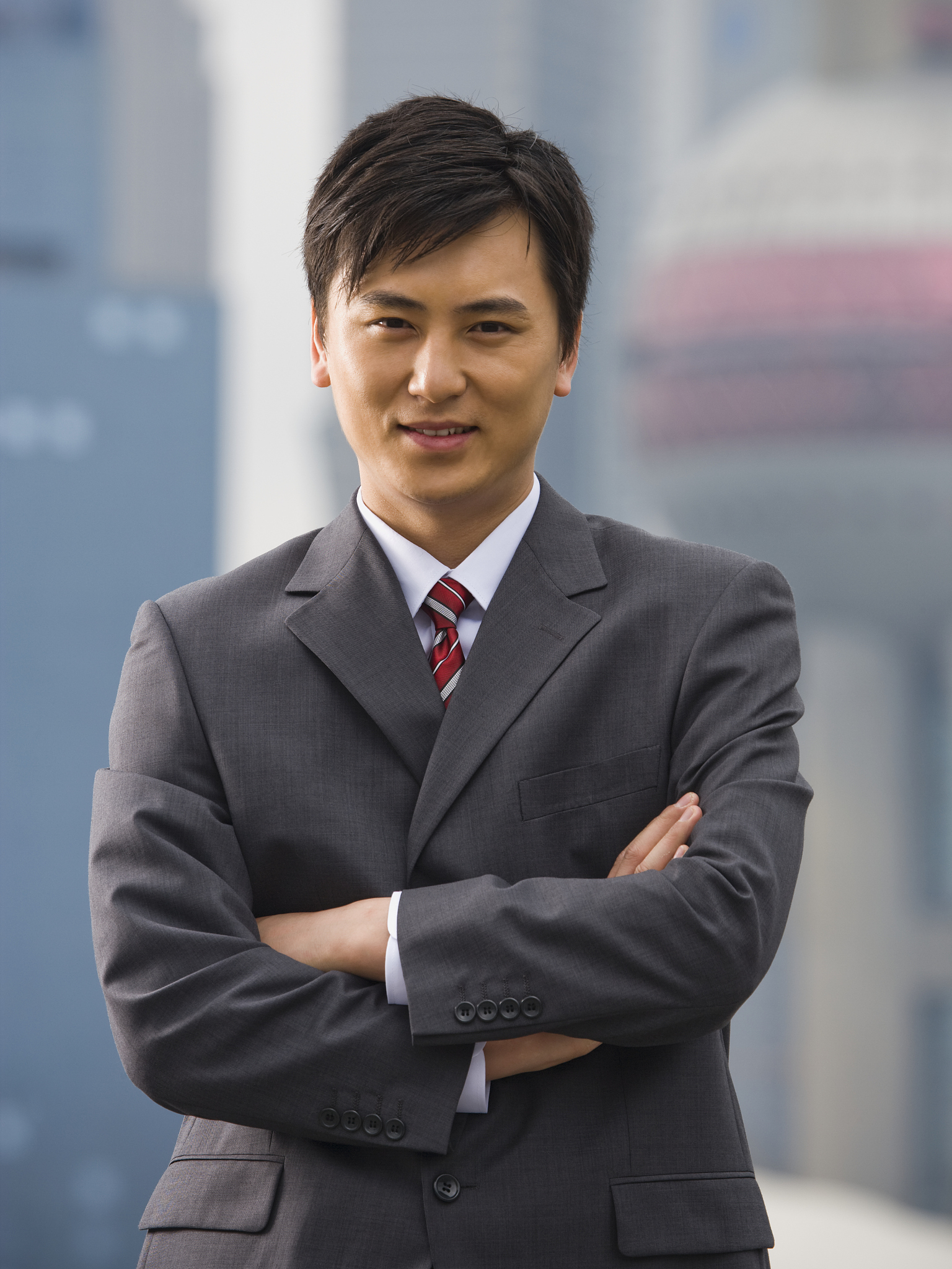 portrait of a businessman with arms crossed outdoors