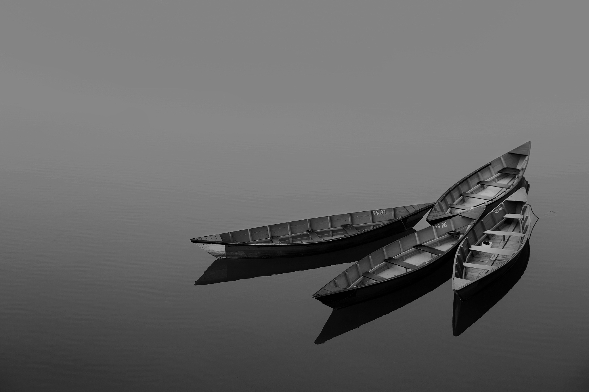 boat moored on lake against sky