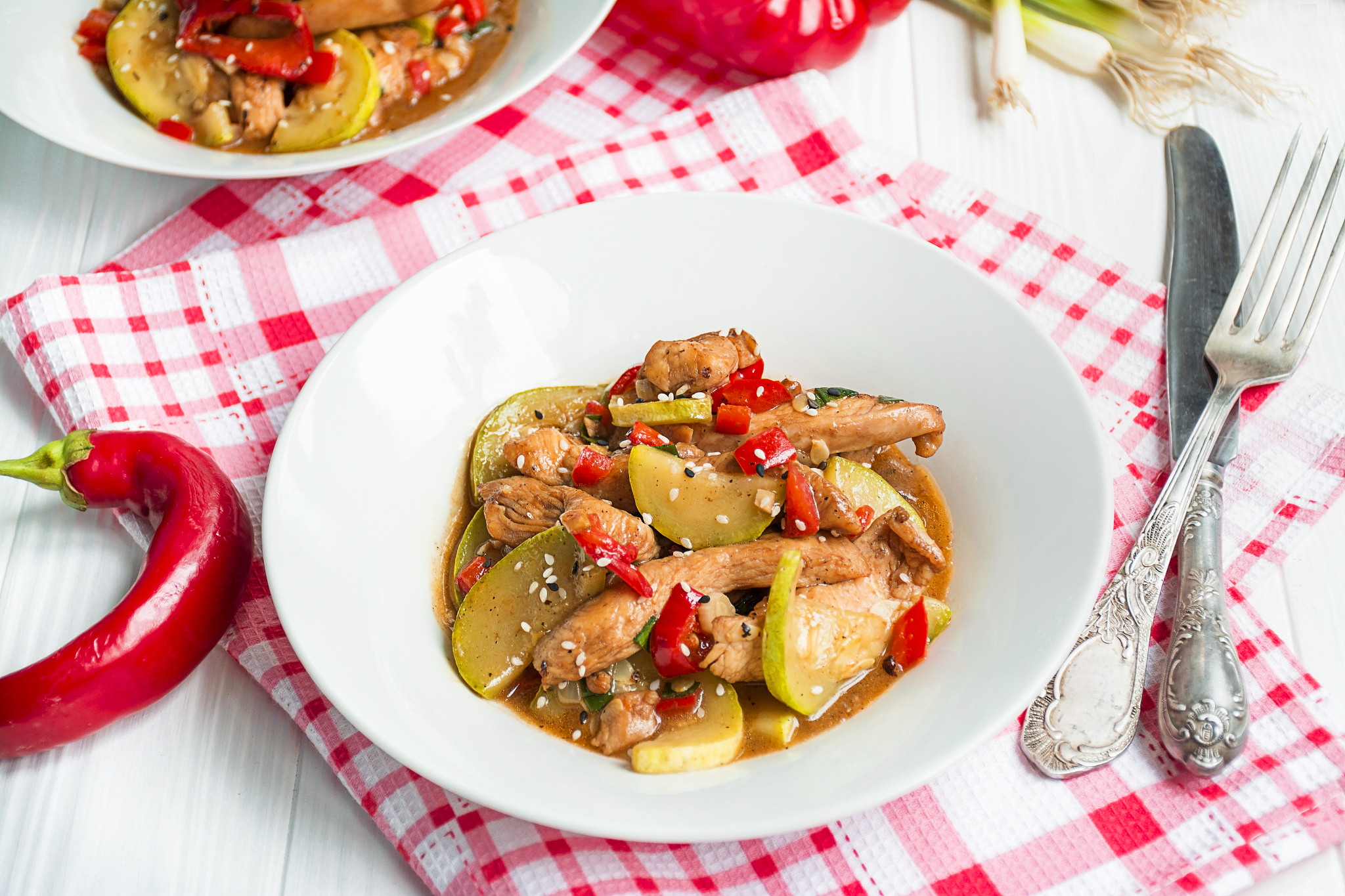 hot vegetable salad with chicken on a light table. asian food. c