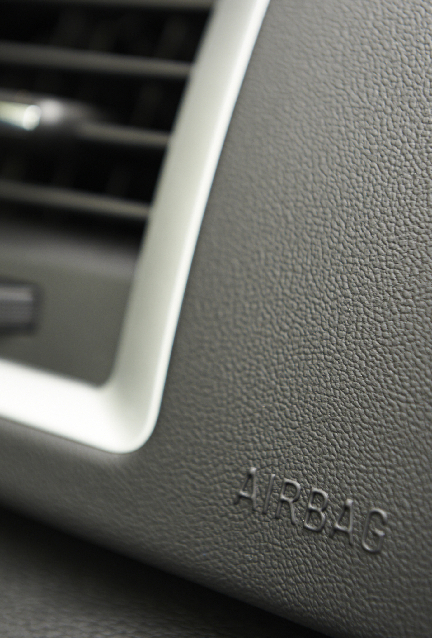 close up of airbag notice on car dashboard