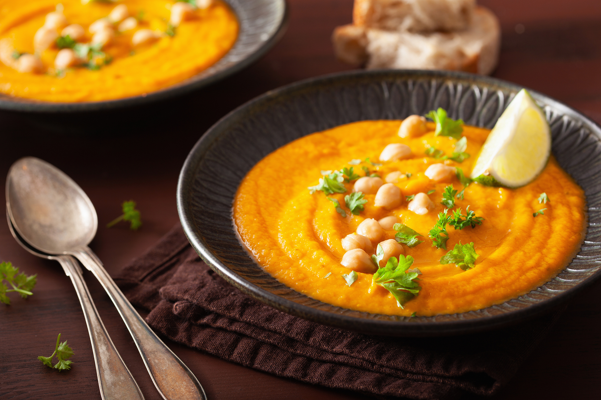 creamy carrot chickpea soup on dark rustic background