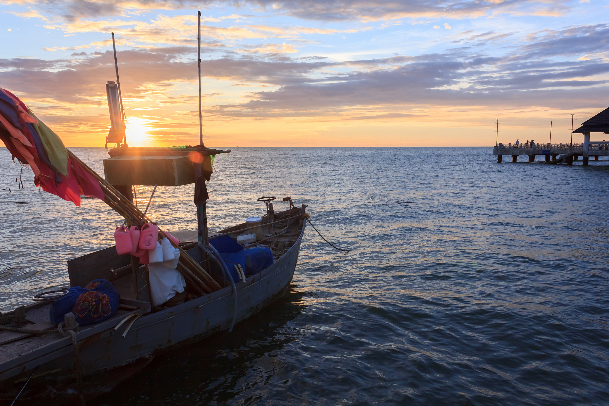 fishing boat in the sea at sunset.