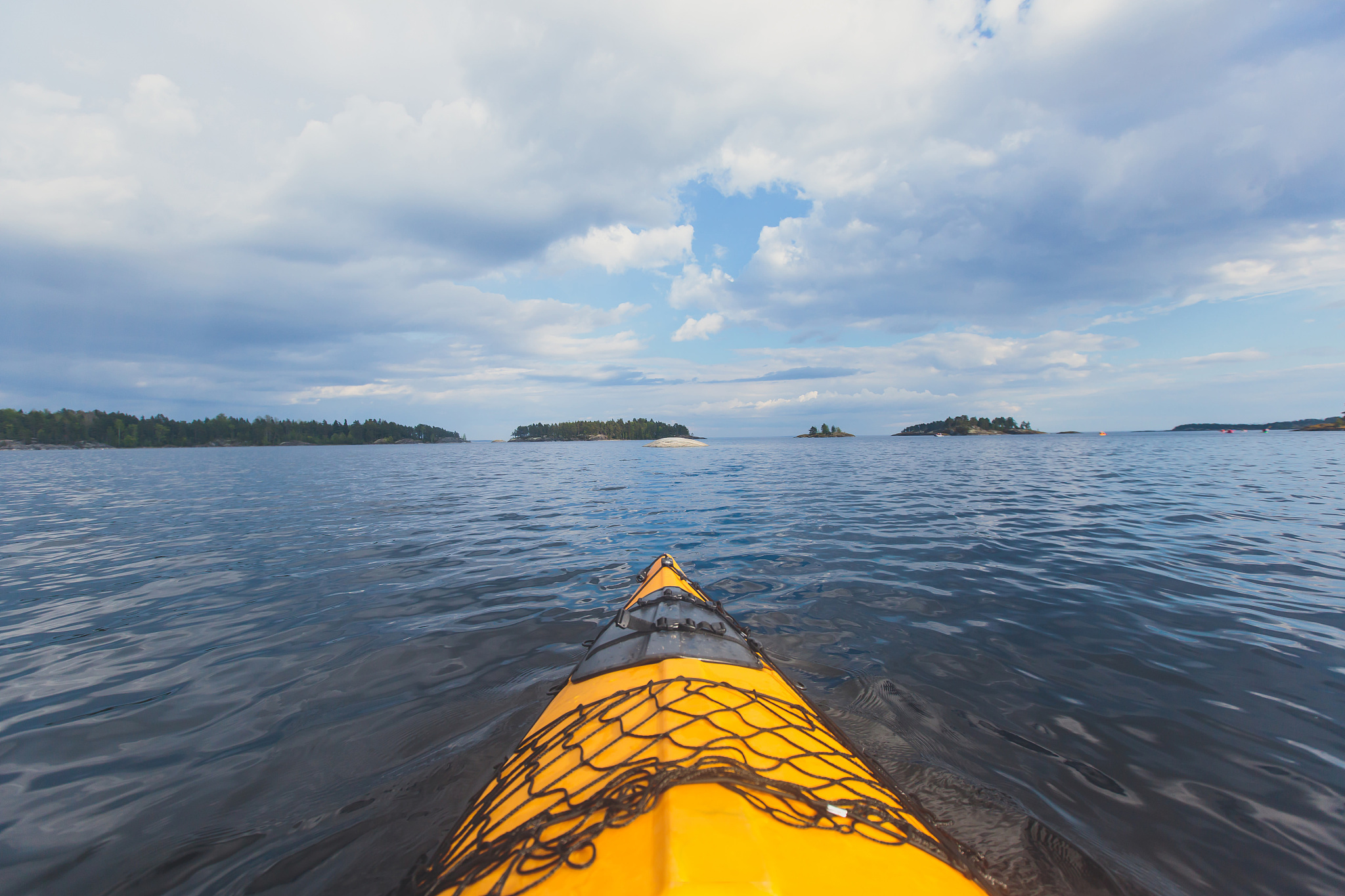 a process of kayaking in the lake skerries, with colorful canoe 