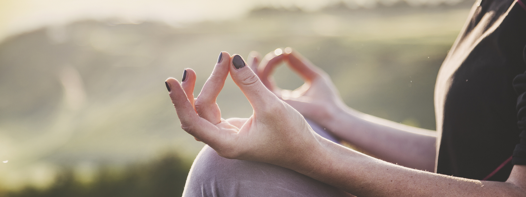 woman doing yoga in beautiful nature background at sunset or sun