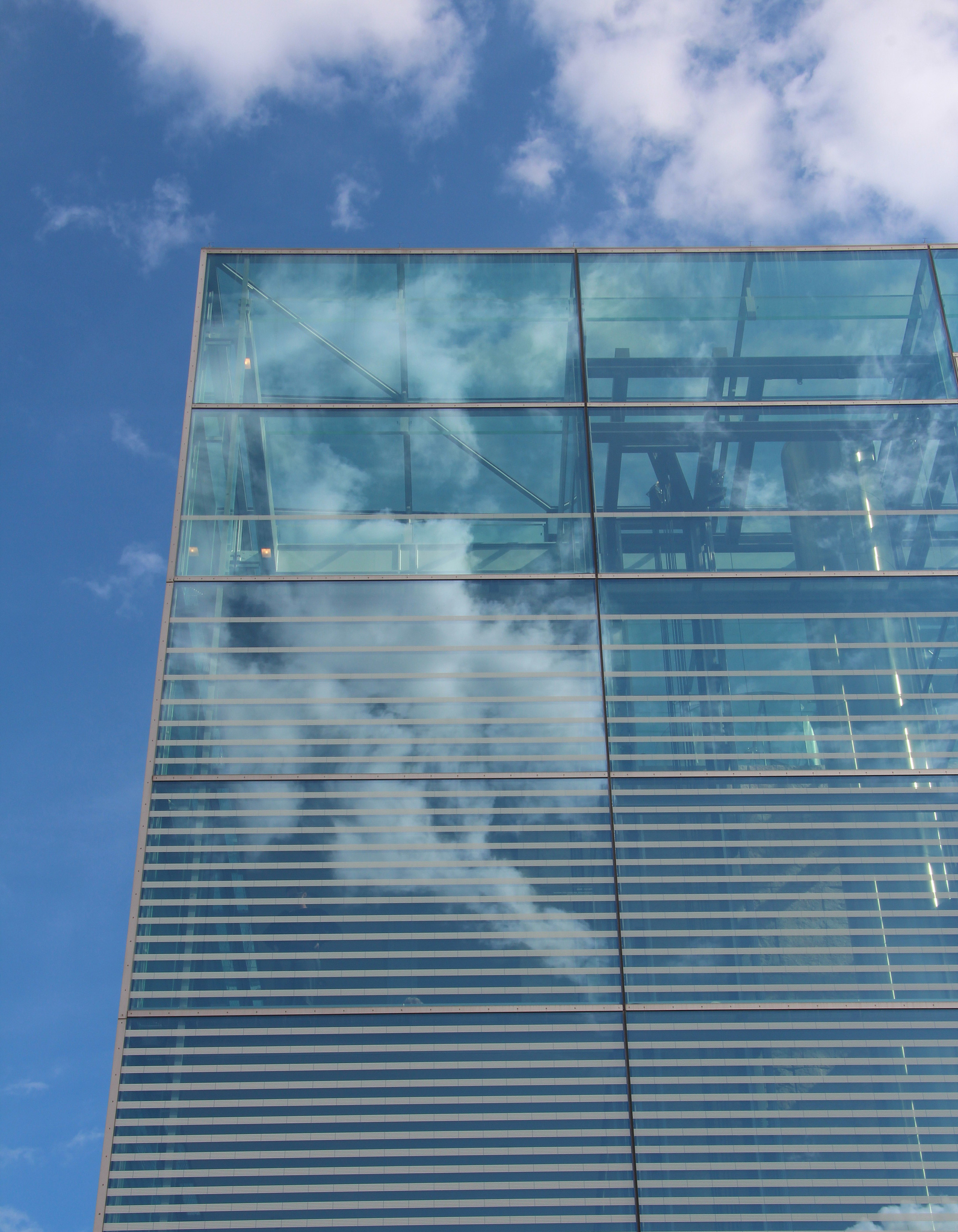 glass facade with clouds reflection