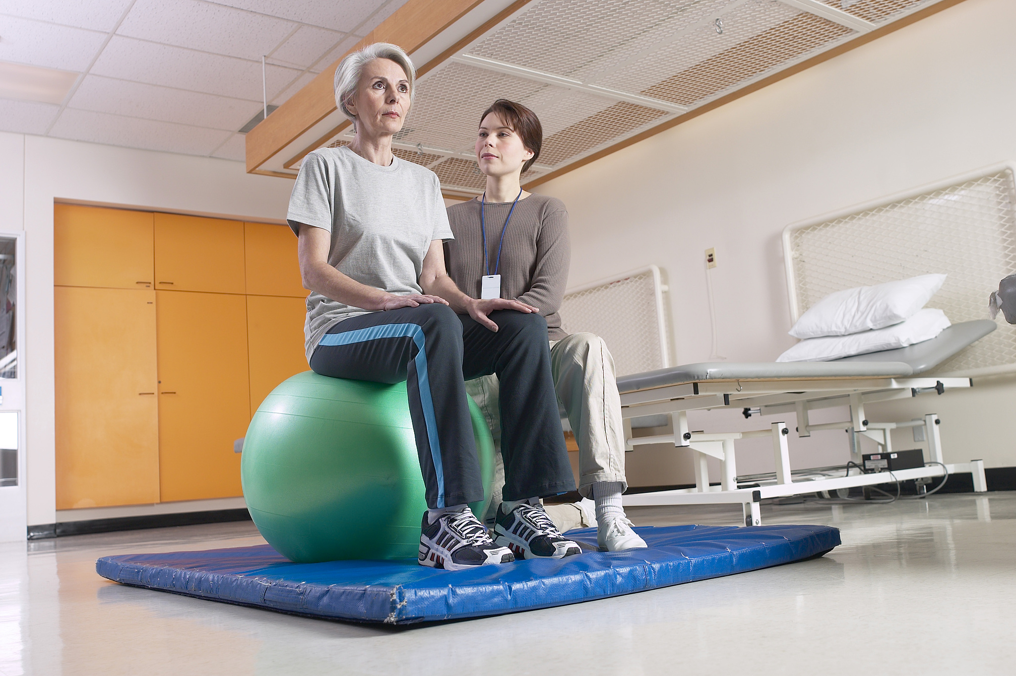 physical therapist helping patient