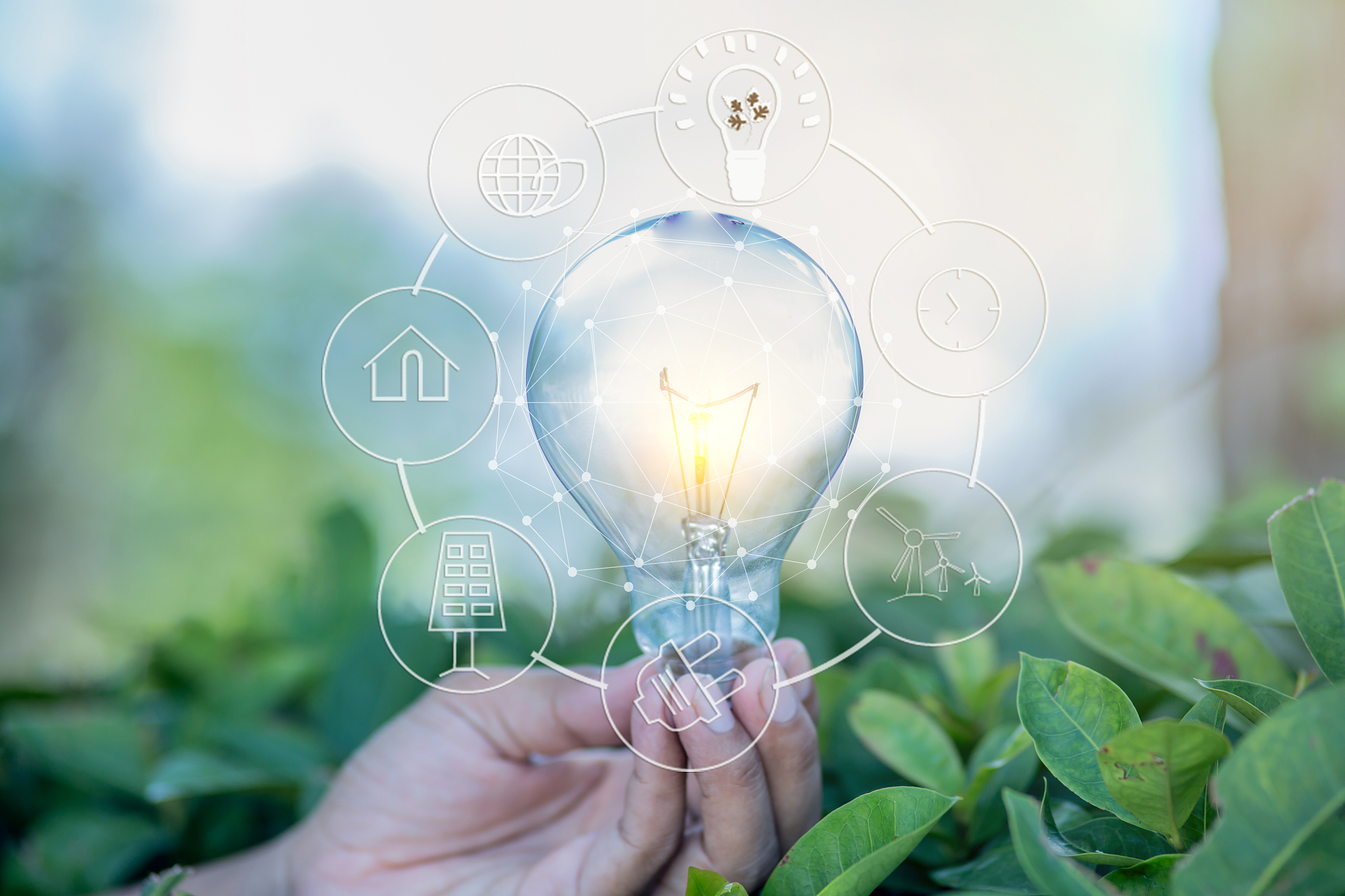 digital composite image of person holding illuminated light bulb