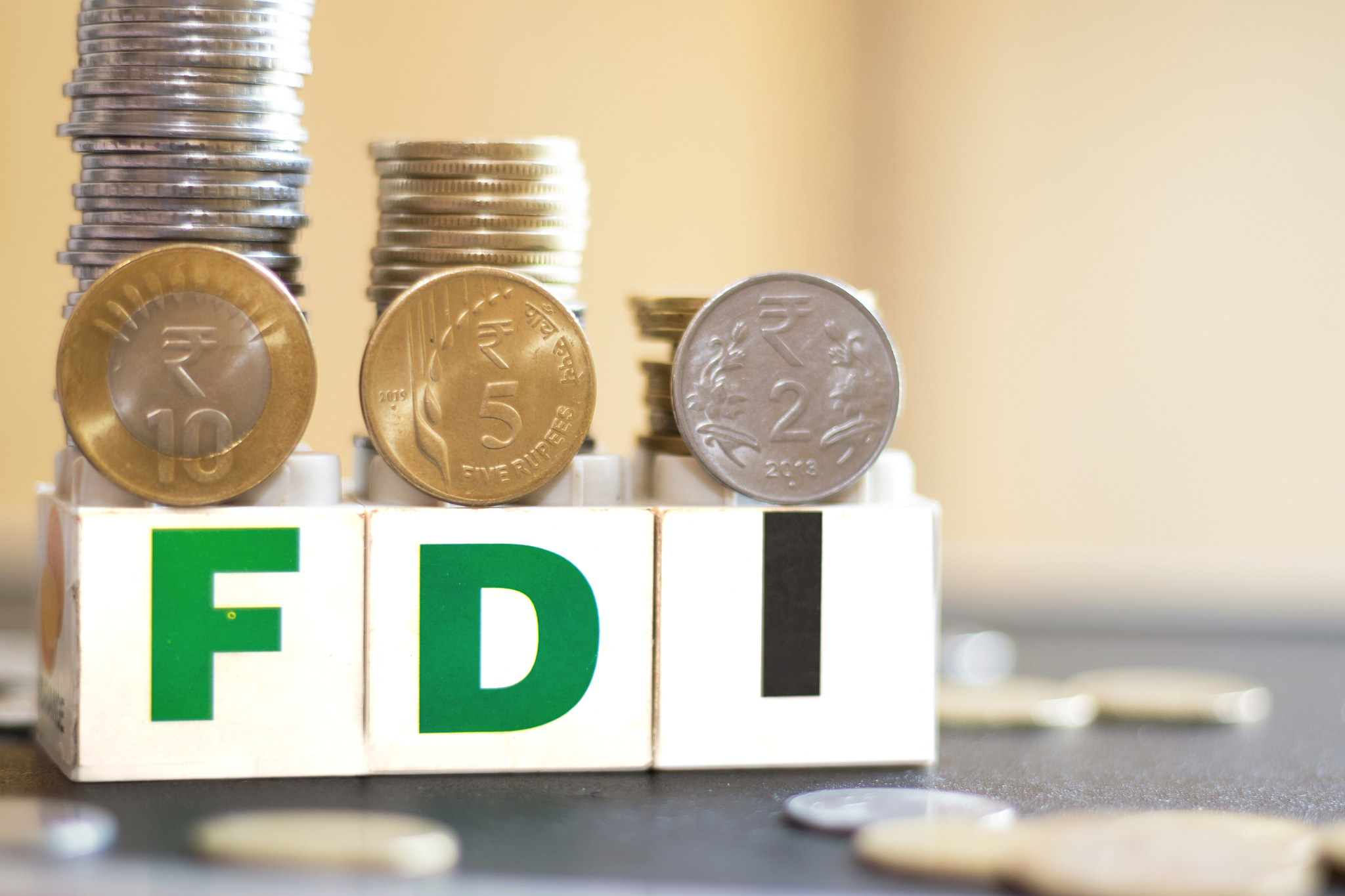 a foreign direct investment wording with a coin of different val