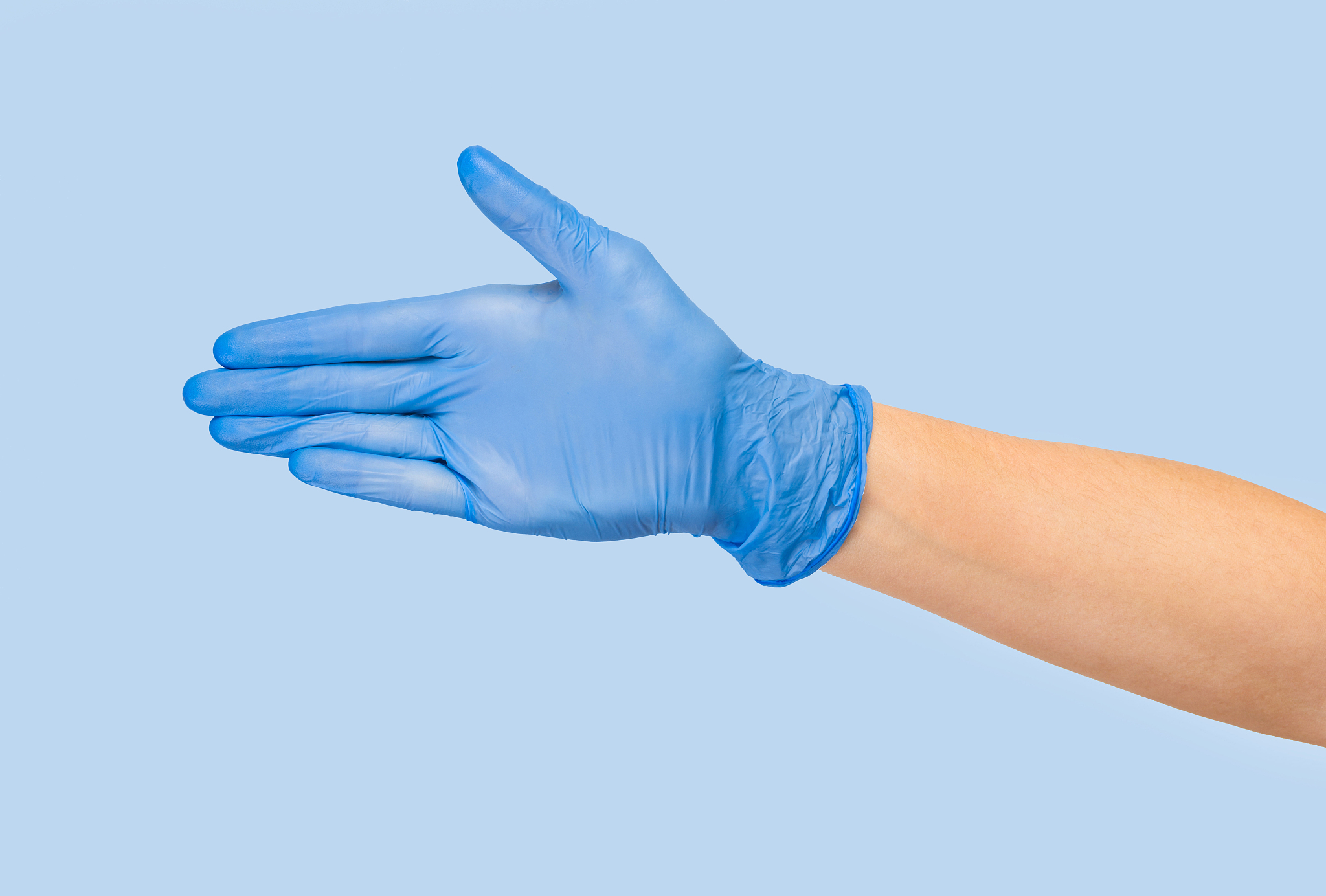 doctor hand glove shows number five front on blue background. in