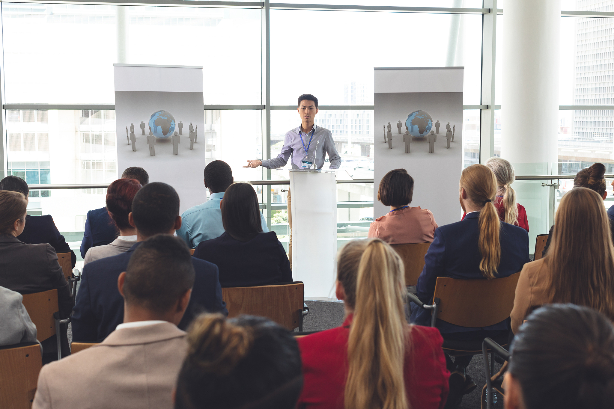 businessman speaks to group at a business seminar