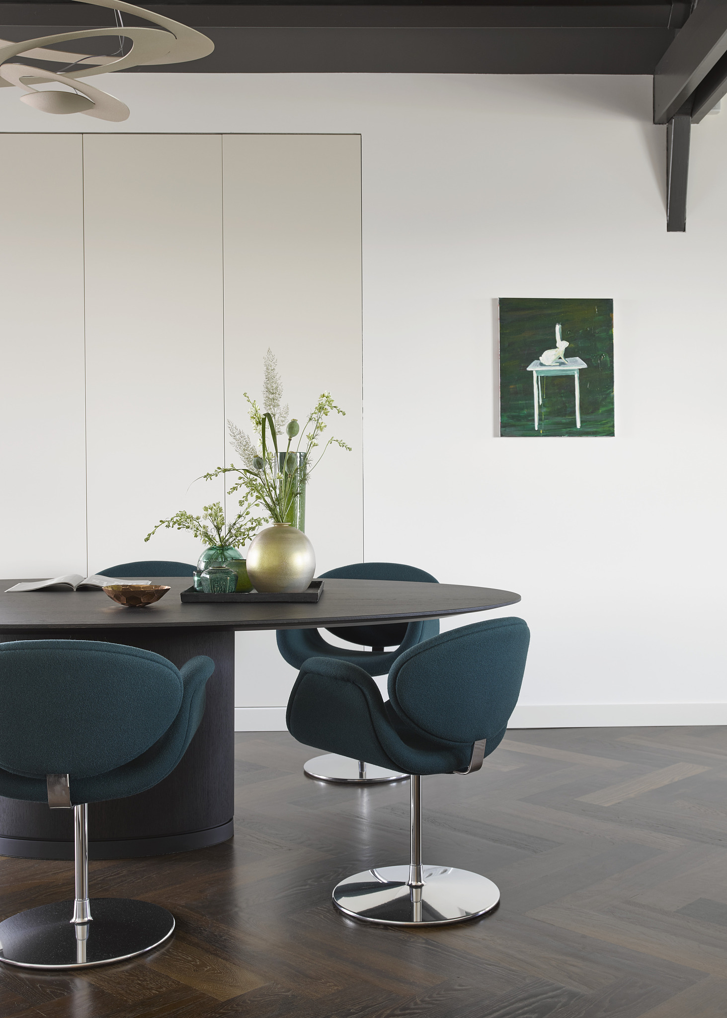 blue upholstered chairs around oval dining table