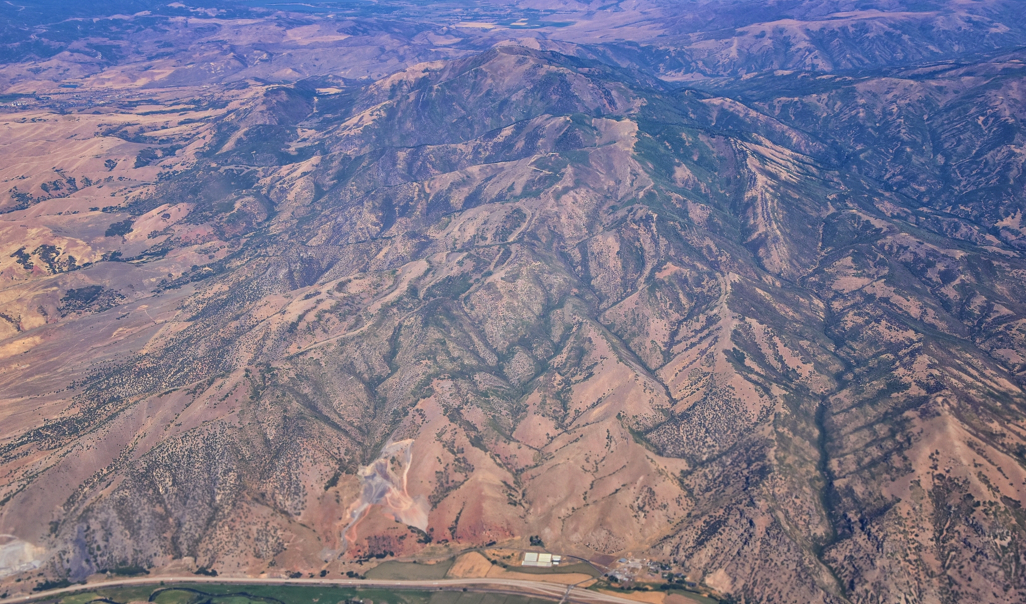 aerial view of topographical rocky mountain landscapes on flight