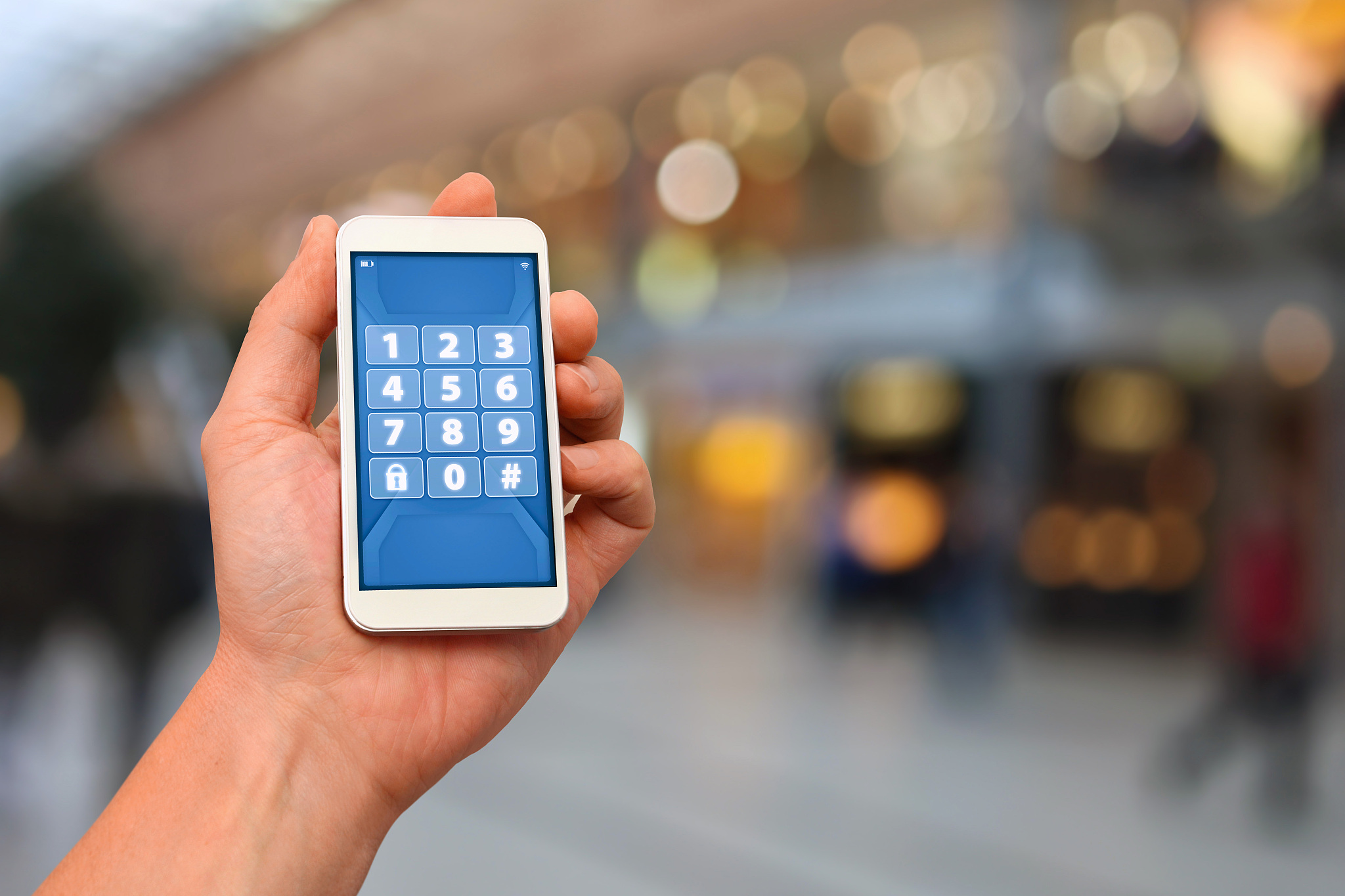 hand holding smartphone with secret pin code