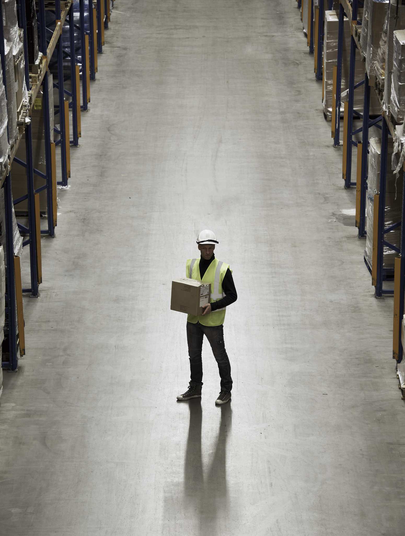 worker carrying box in warehouse