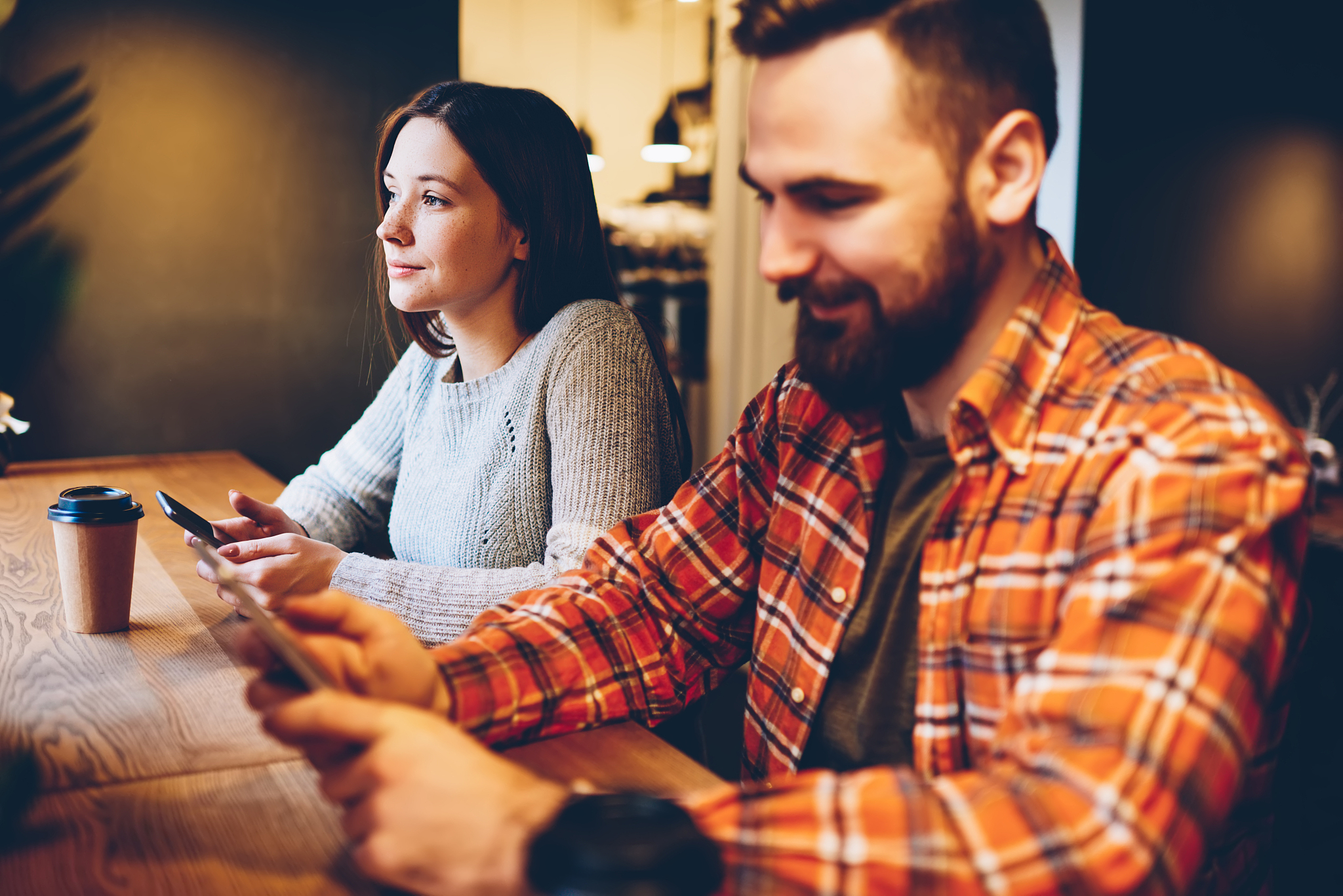 addicted hipster friends blogging on smartphones and browsing in