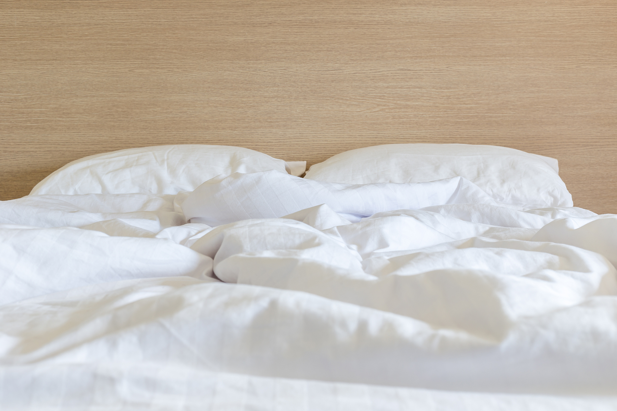 white bedding sheets and pillow, messy bed concept