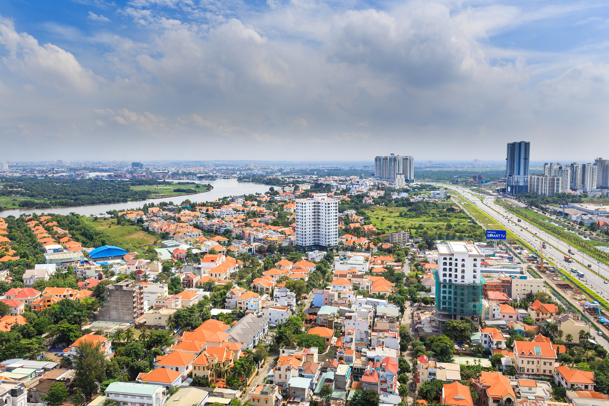 high angle view of buildings in city against sky on sunny day