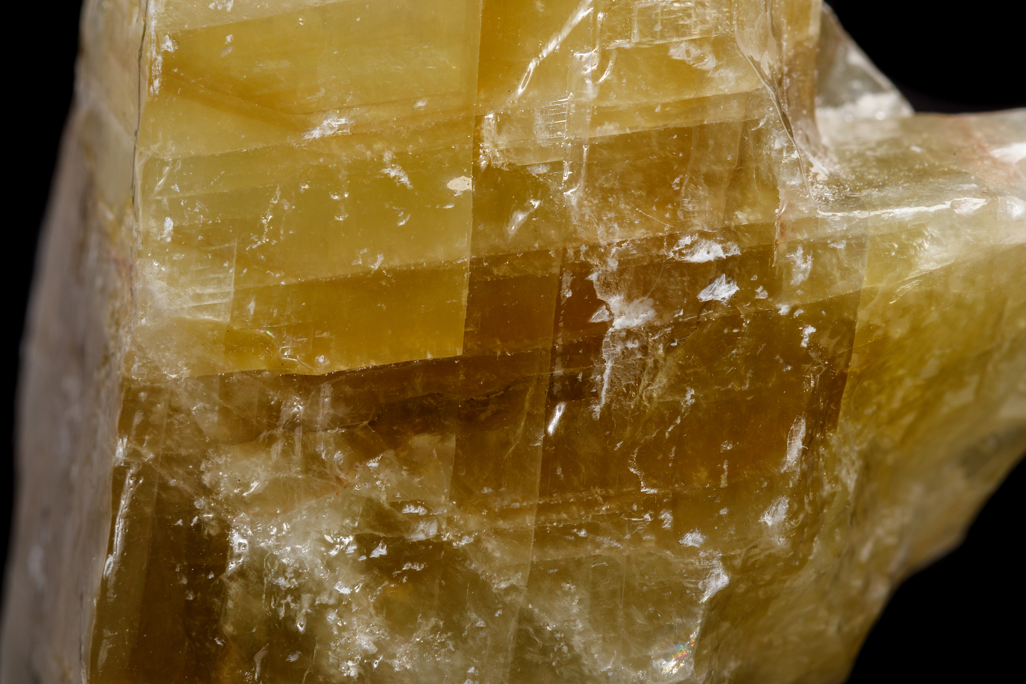 macro mineral stone yellow calcite on a black background