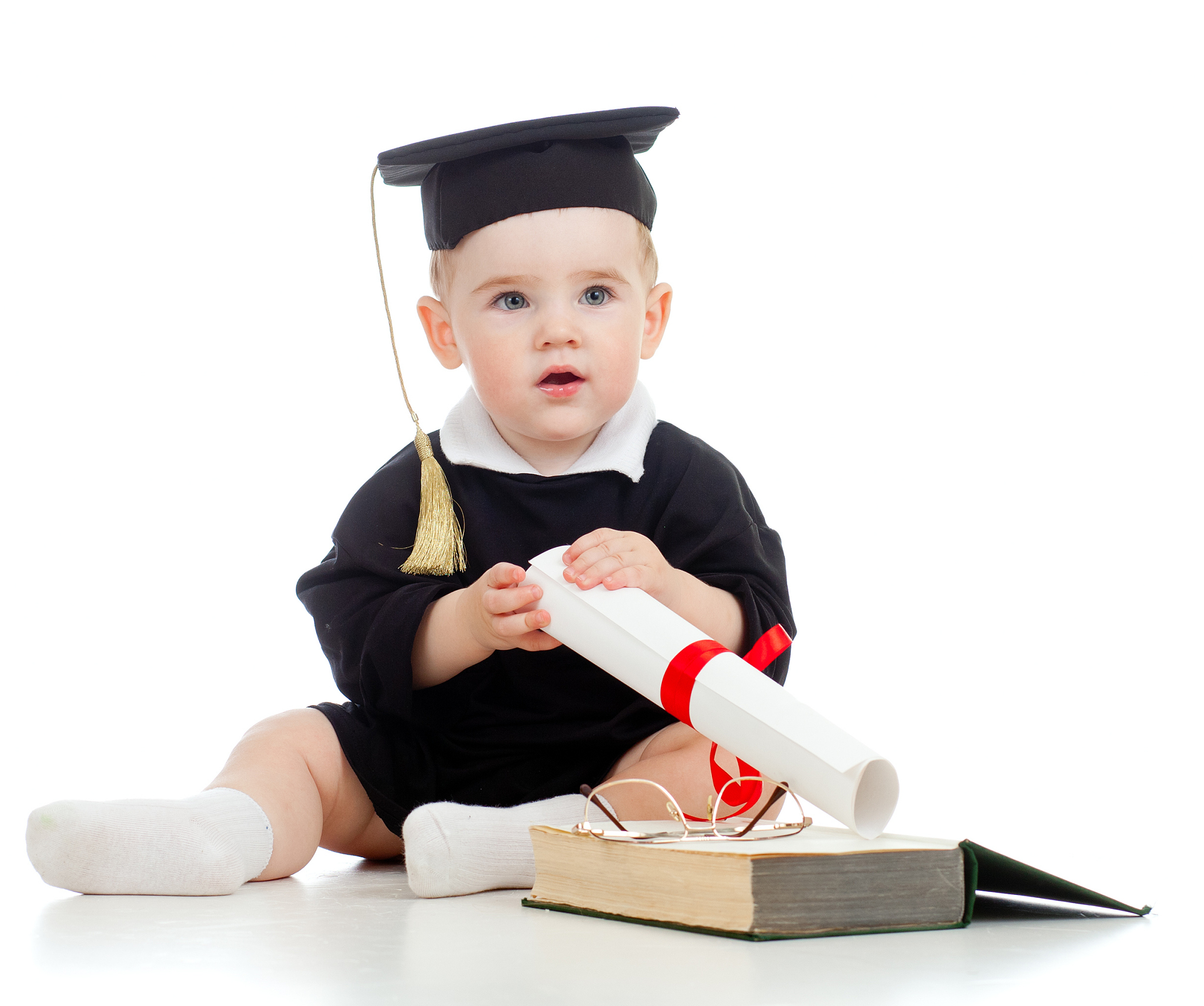 baby dressed in graduation attire, posing with scroll & book