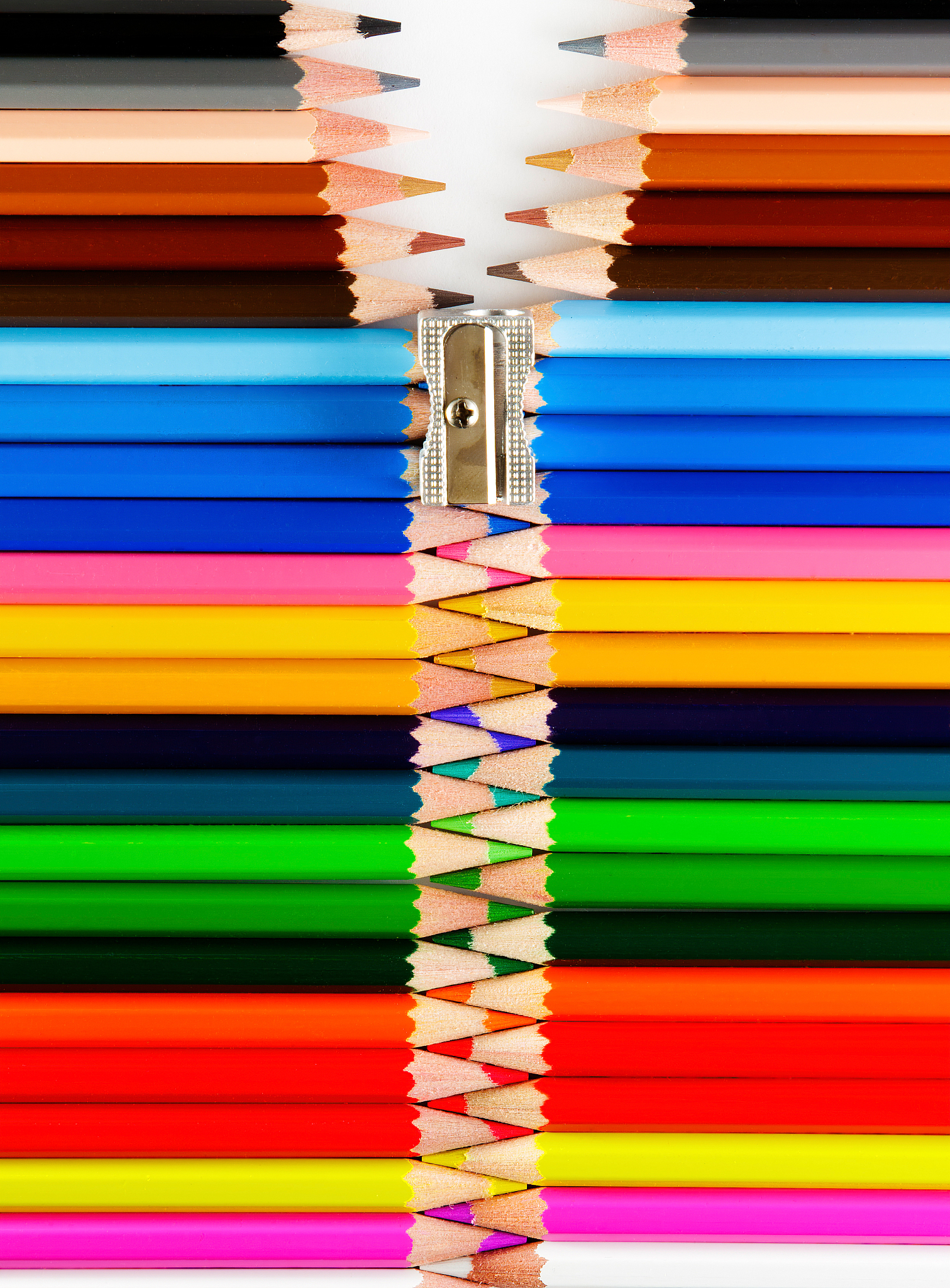 set of pastel colored pencils and a sharpener forming a zipper
