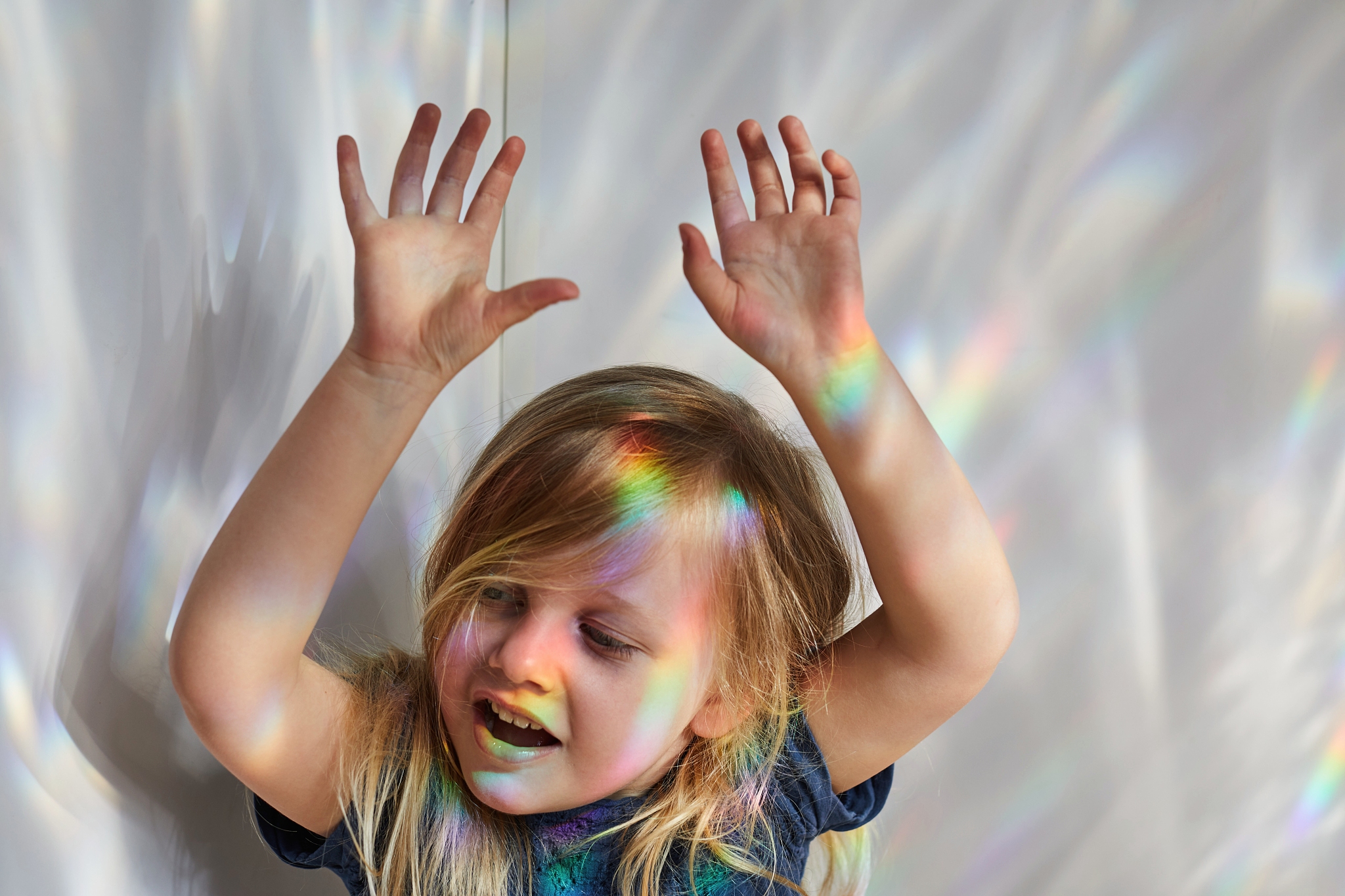 child playing with rainbows