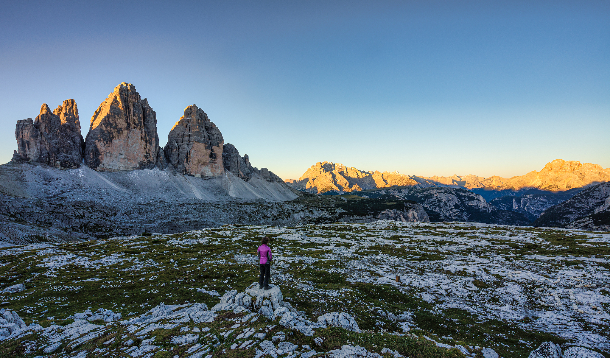 woman looking at sunrise, tre cime di lavaredo, dolomites, south