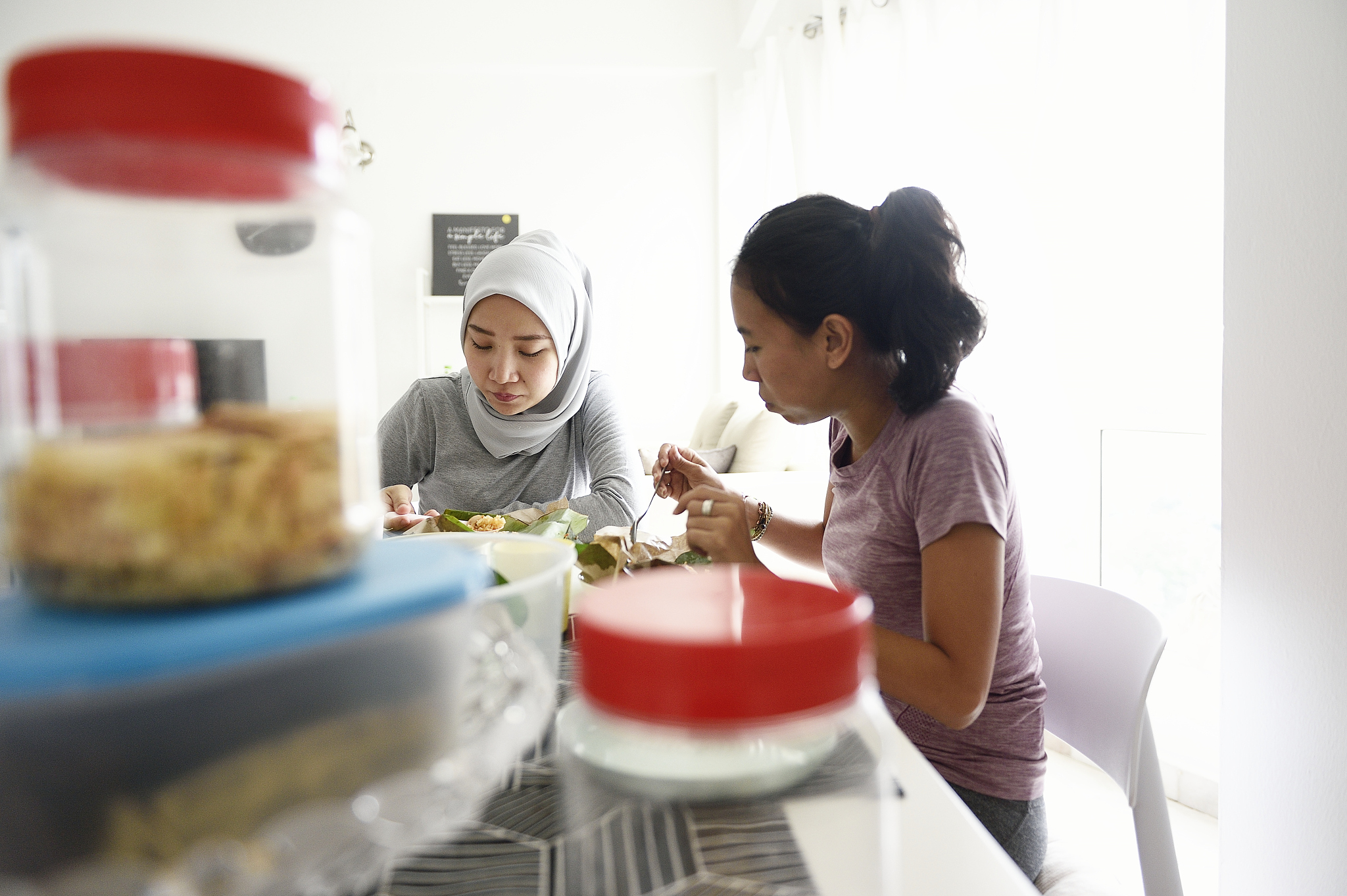 malay women having breakfast at home together