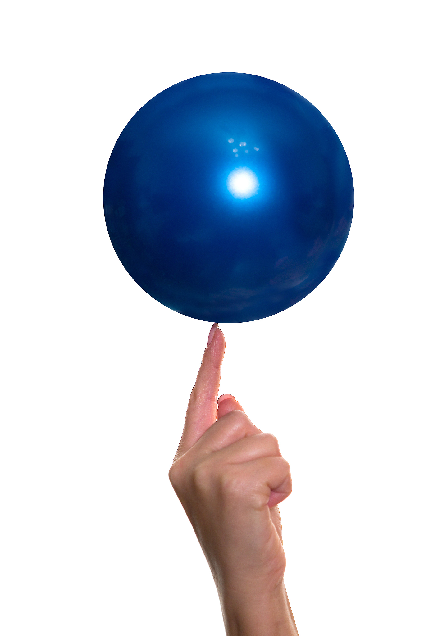 a woman's hand holds a ball on her finger.