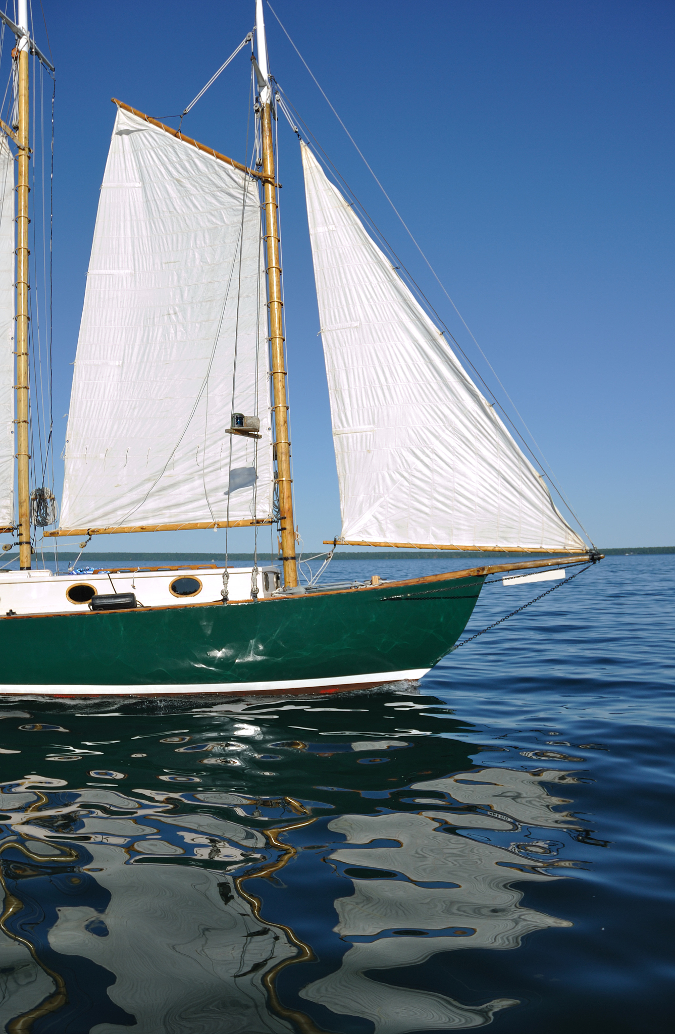 jib, foresail, and wooden mast of schooner sailboat