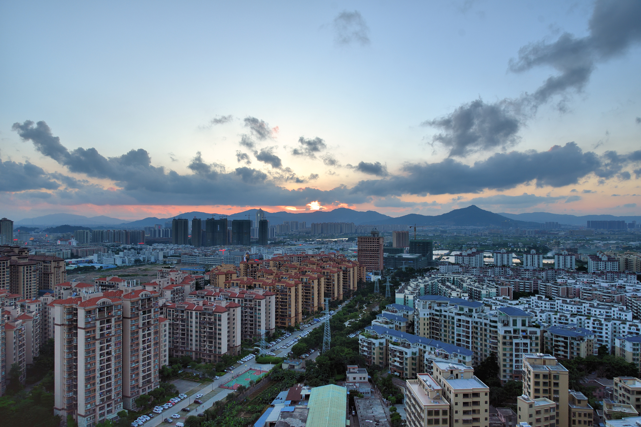 town skyline under cloud sky and sunset